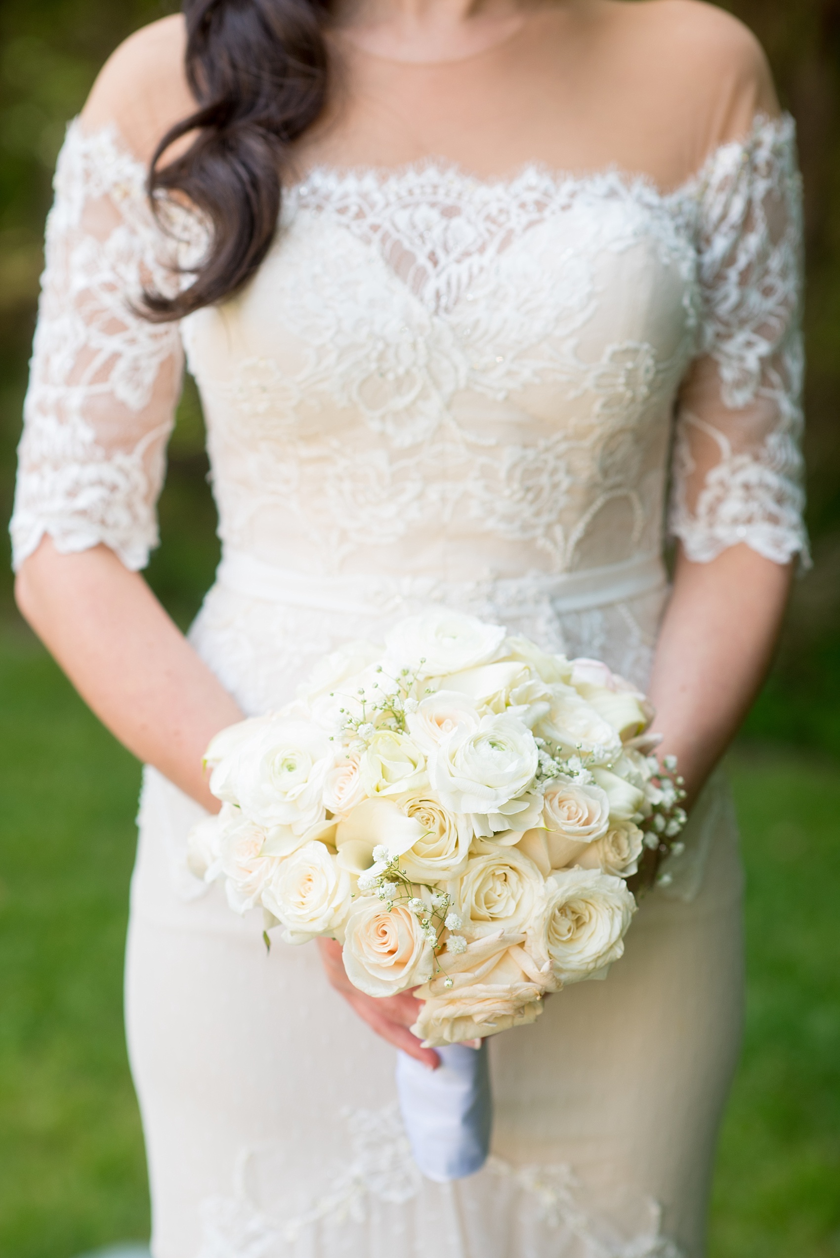 Mikkel Paige Photography photo of the bride in her long sleeve Inbal Dror gown with a rose bouquet on her wedding day at Temple Emanu-El in Closter, NJ. 