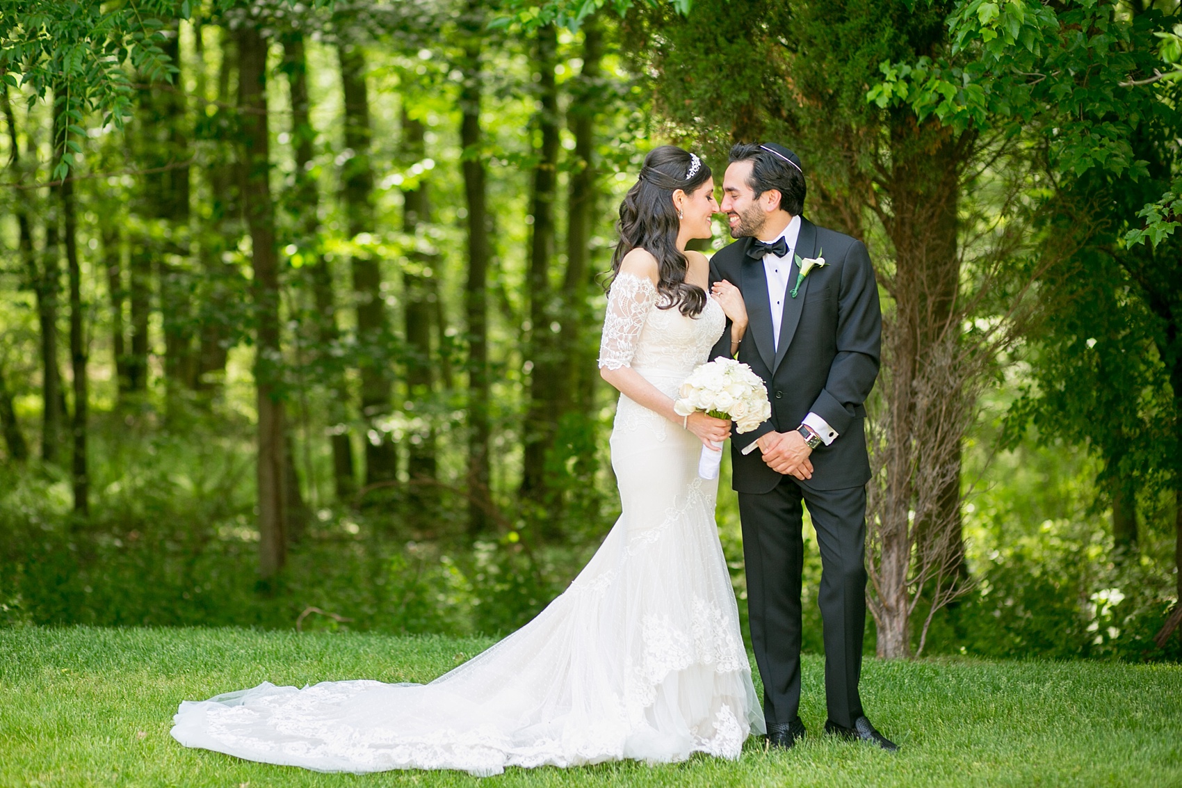 Mikkel Paige Photography photo of the bride in her long sleeve Inbal Dror gown with a rose bouquet on her wedding day at Temple Emanu-El in Closter, NJ. 