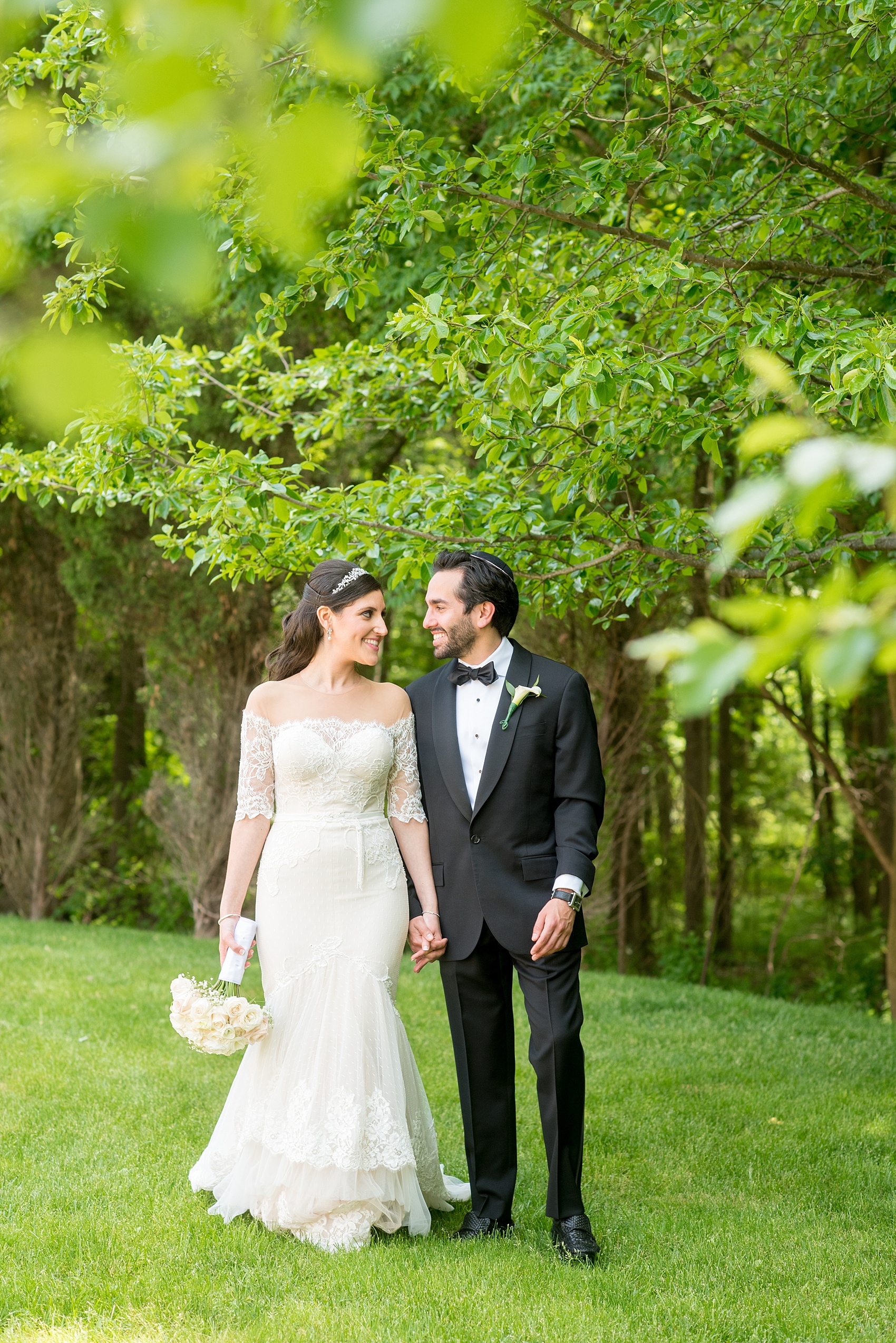 Mikkel Paige Photography photo of the bride in her long sleeve Inbal Dror gown and groom on their wedding day at Temple Emanu-El in Closter, NJ. 