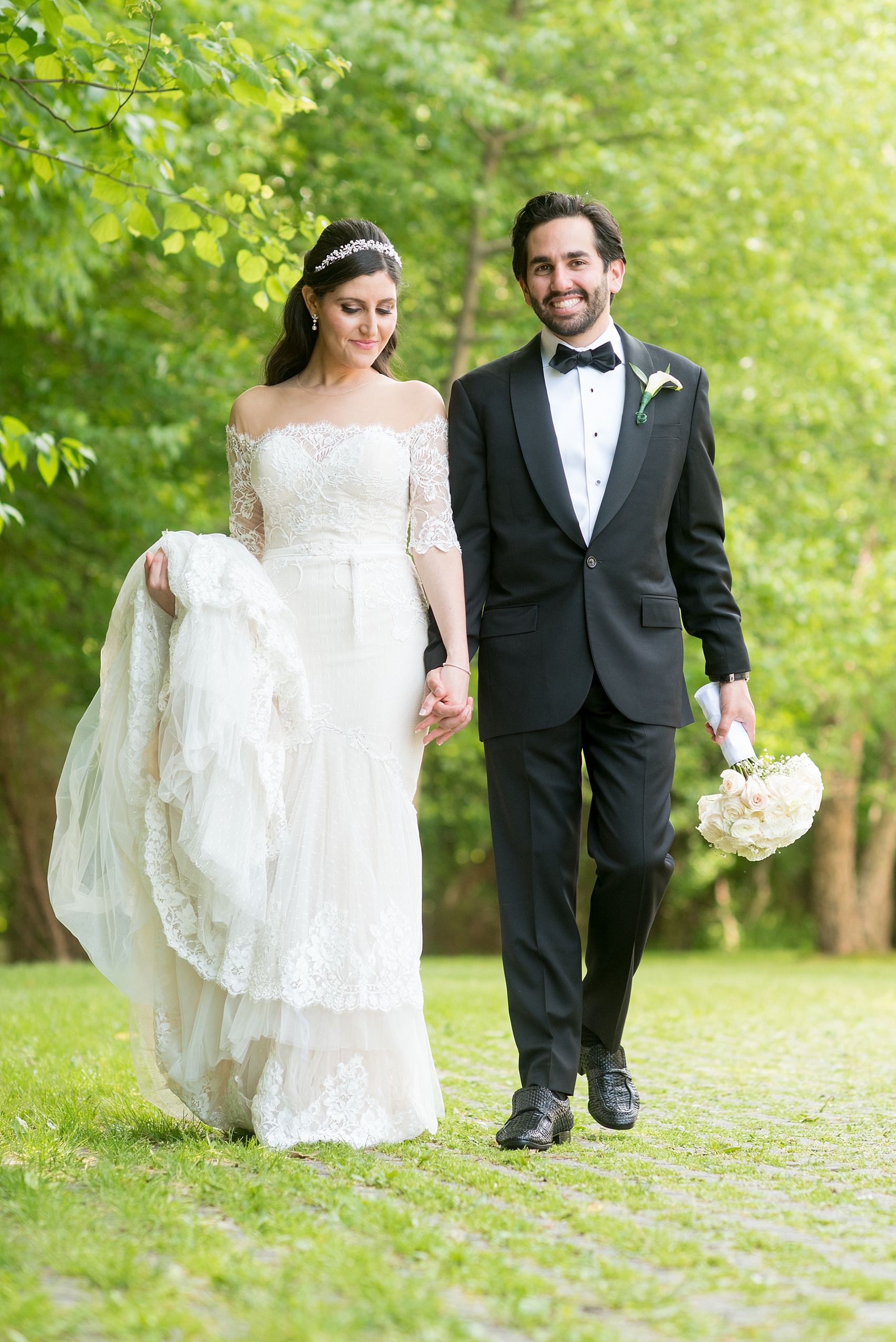 Mikkel Paige Photography photo of the bride in her long sleeve Inbal Dror gown and groom on their wedding day at Temple Emanu-El in Closter, NJ. 
