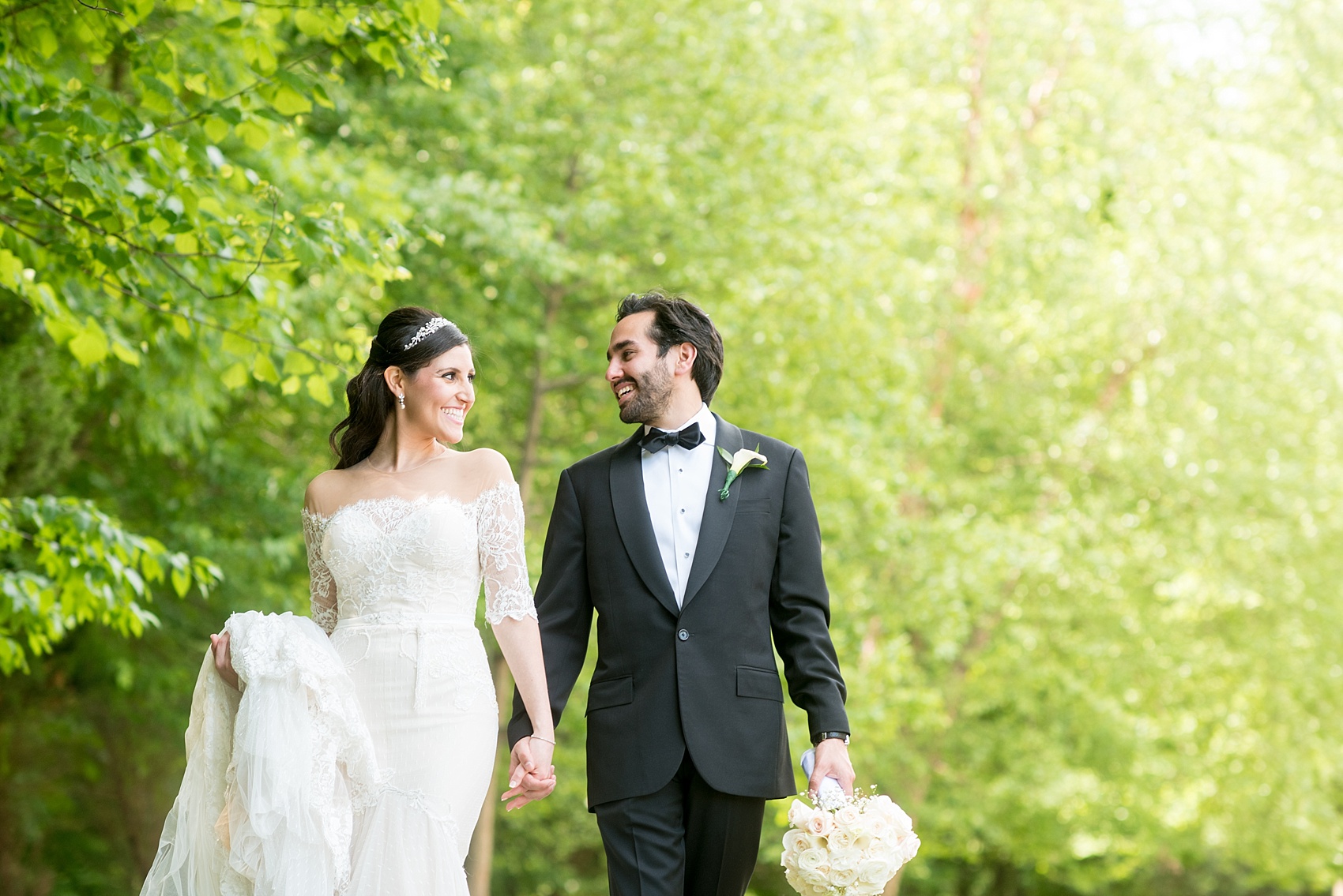 Mikkel Paige Photography photo of the bride in her long sleeve Inbal Dror gown and groom on their wedding day at Temple Emanu-El in Closter, NJ. 