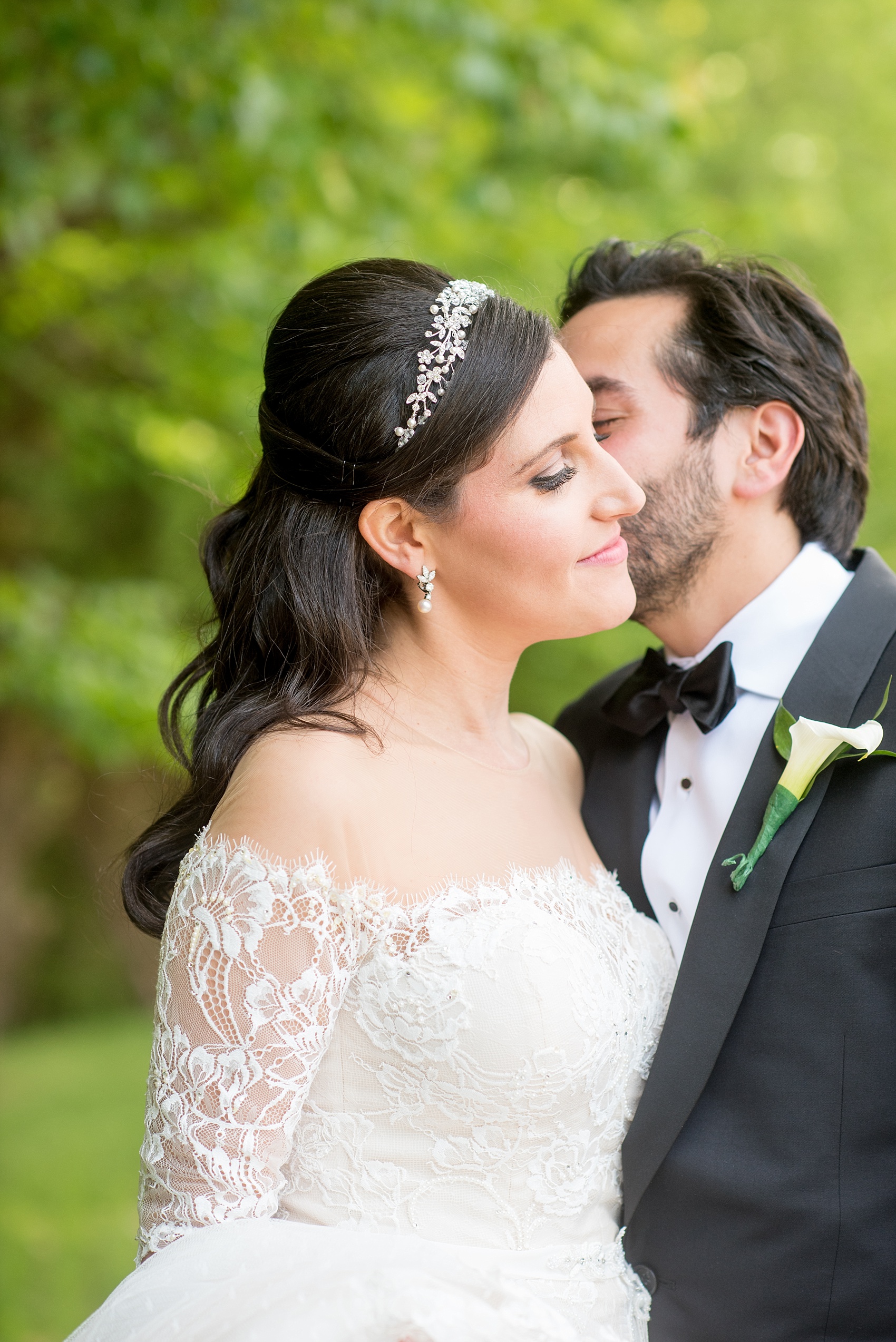 Mikkel Paige Photography photo of the bride in her long sleeve Inbal Dror gown and groom on their wedding day at Temple Emanu-El in Closter, NJ. 