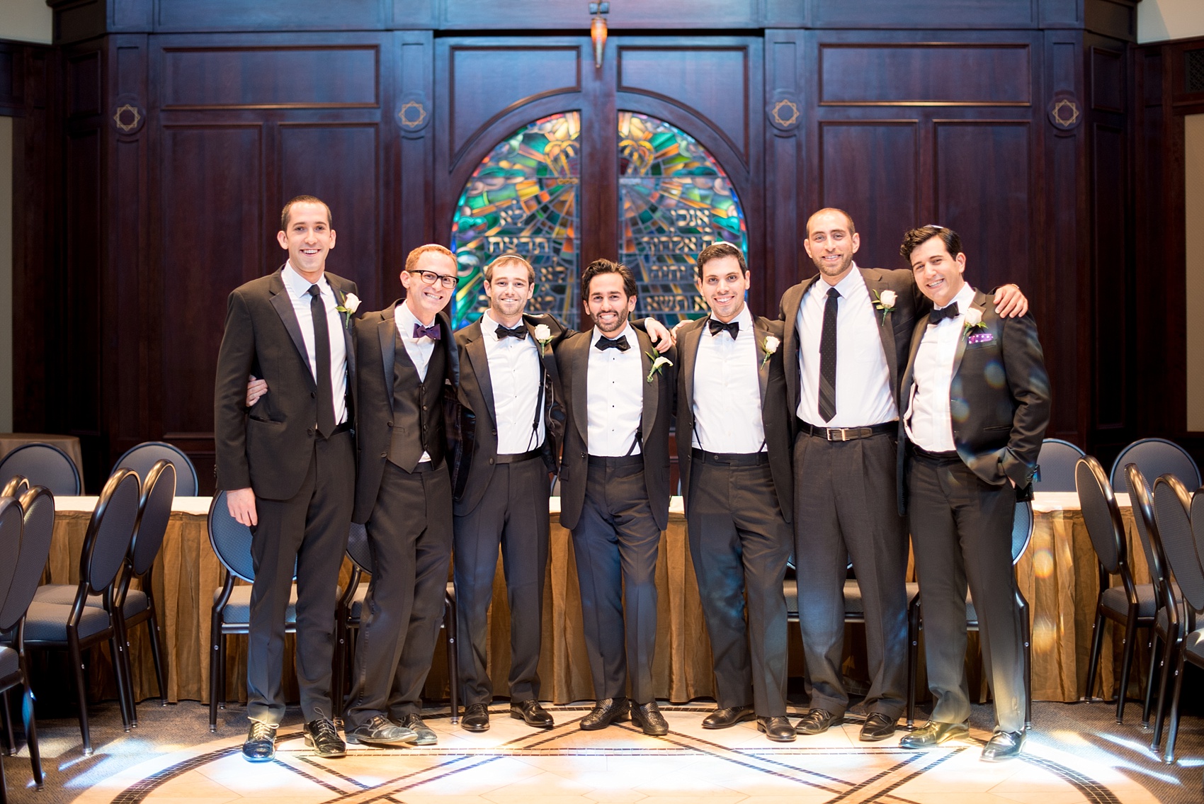 Mikkel Paige Photography photo of the groom at his Jewish religion tish at Temple Emanu-El in Closter, NJ.