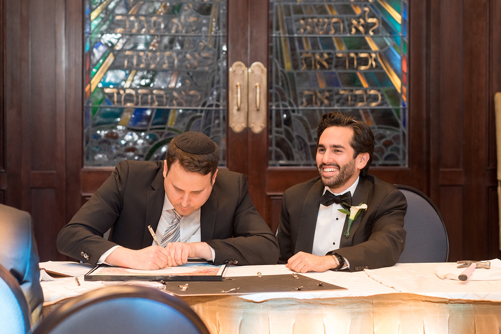 Mikkel Paige Photography photo of the groom at his Jewish religion tish at Temple Emanu-El in Closter, NJ.