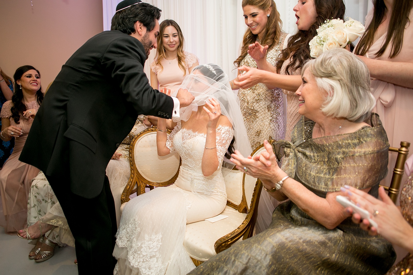 Mikkel Paige Photography photo of the bride and groom lowering her veil for a traditional Jewish ceremony at Temple Emanu-El in Closter, NJ.