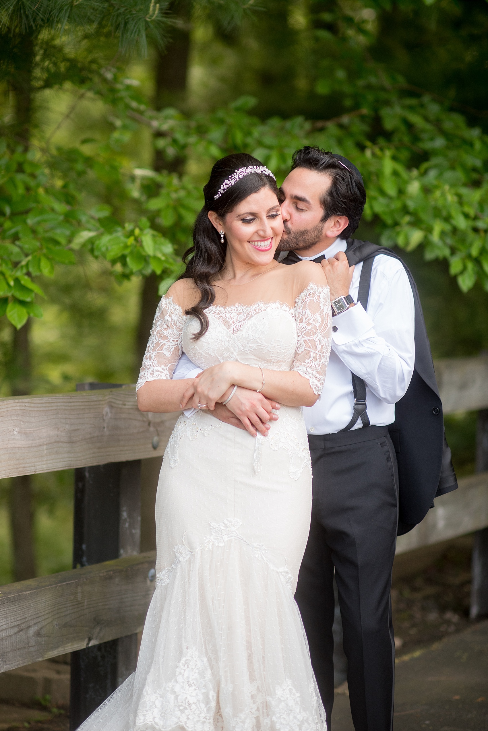 Mikkel Paige Photography photo of the bride in her long sleeve Inbal Dror gown and groom on their wedding day at Temple Emanu-El in Closter, NJ. 