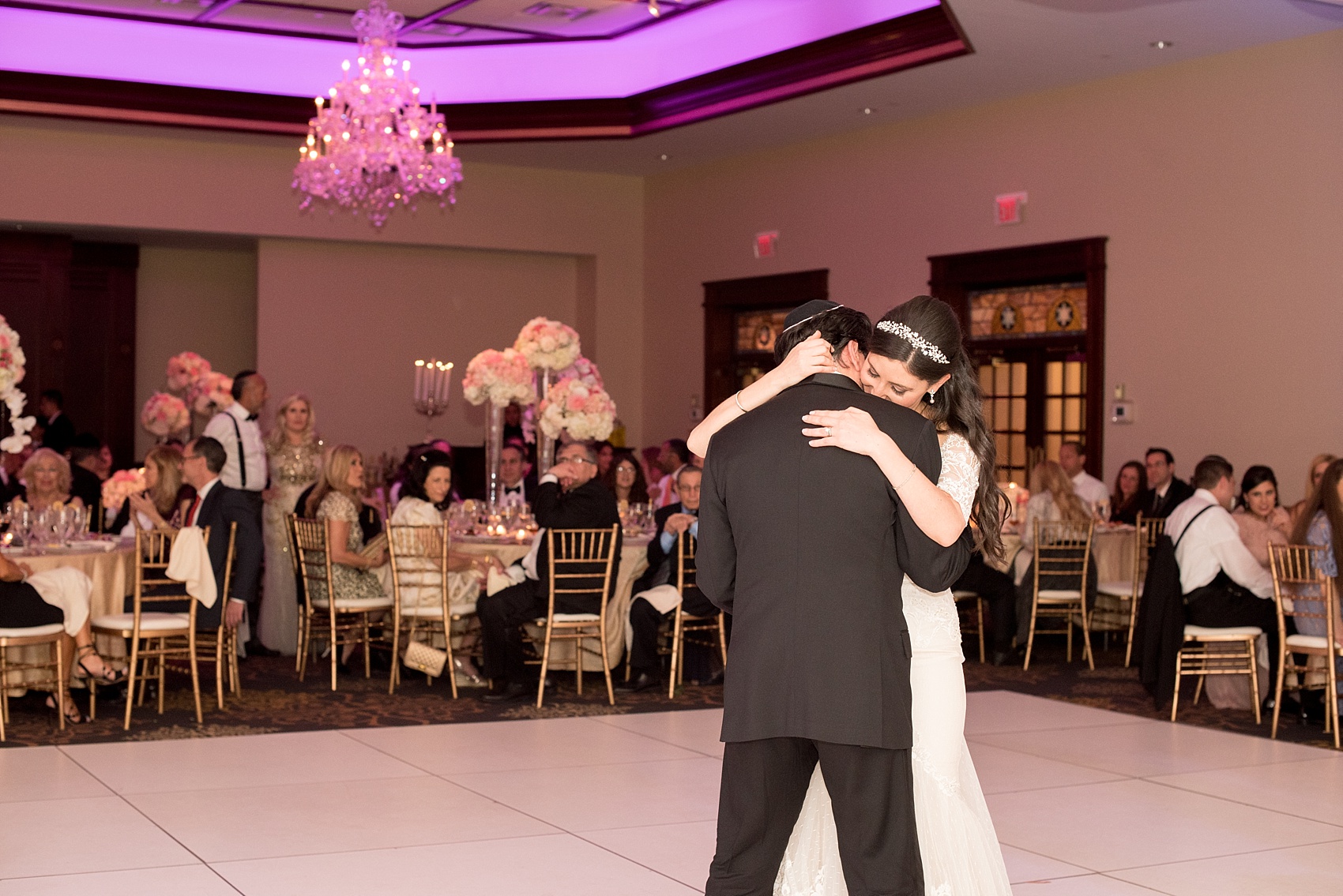 Mikkel Paige Photography photos of an elegant reception with pink and white details at Temple Emanu-El in Closter, NJ with floral centerpieces high and low.