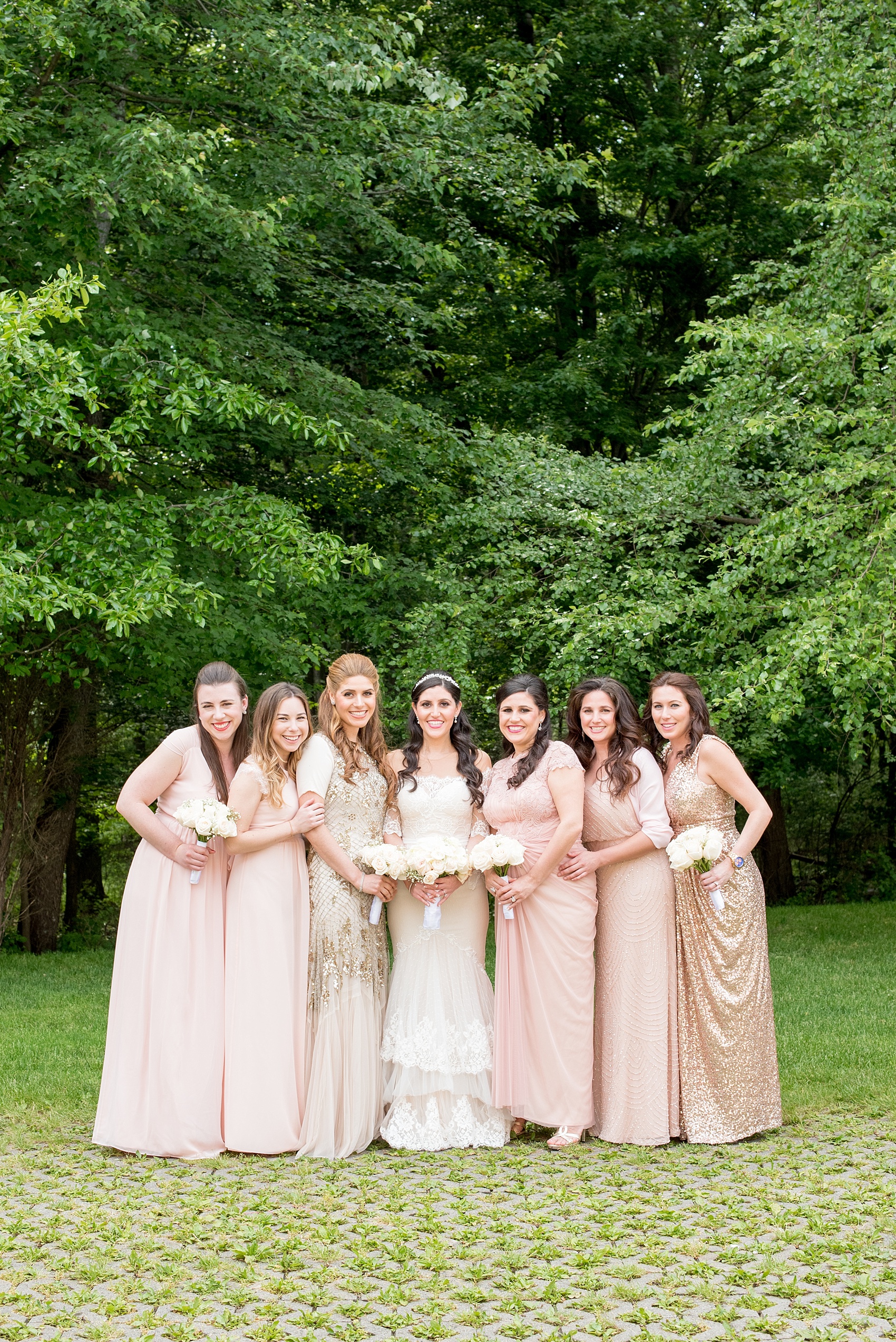 Mikkel Paige Photography photo of the bridesmaids in light pink blush mismatched dresses of their choice. Orthodox Jewish wedding at Temple Emanu-El in Closter, NJ.