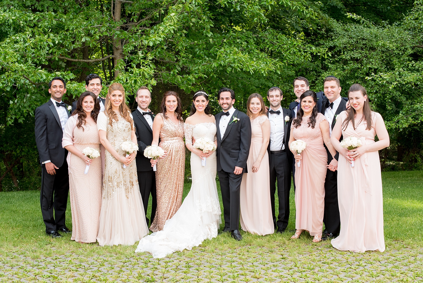 Mikkel Paige Photography photo of a wedding party with bridesmaids in light pink blush mismatched dresses of their choice. Orthodox Jewish wedding at Temple Emanu-El in Closter, NJ.