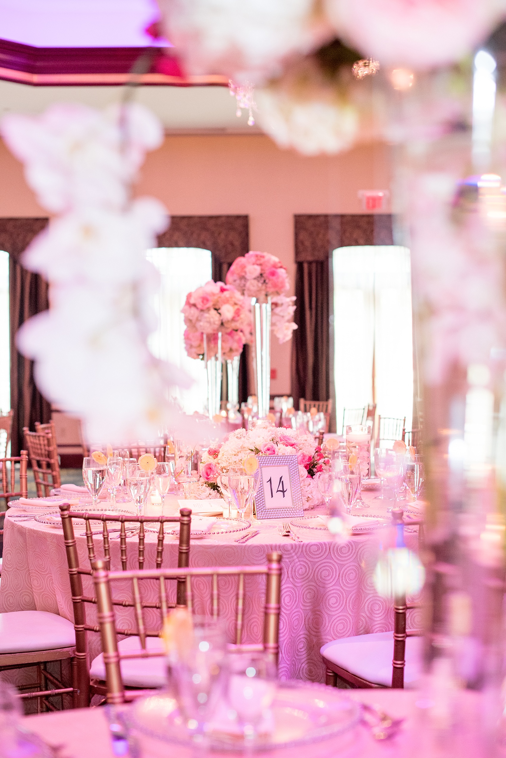 Mikkel Paige Photography photos of an elegant reception with pink and white details at Temple Emanu-El in Closter, NJ with floral centerpieces high and low.