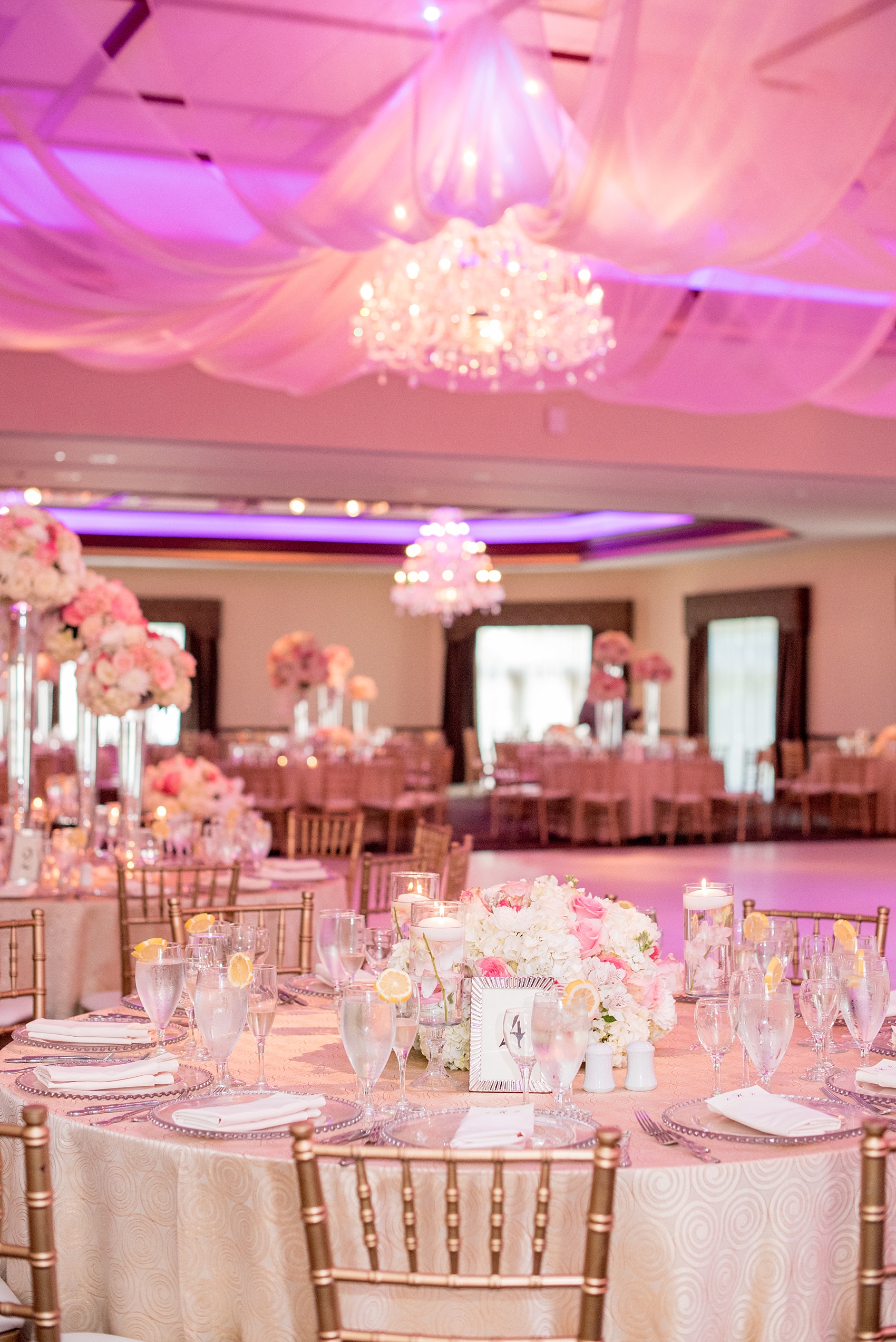 Mikkel Paige Photography photos of an elegant reception with pink and white details at Temple Emanu-El in Closter, NJ with floral centerpieces high and low.