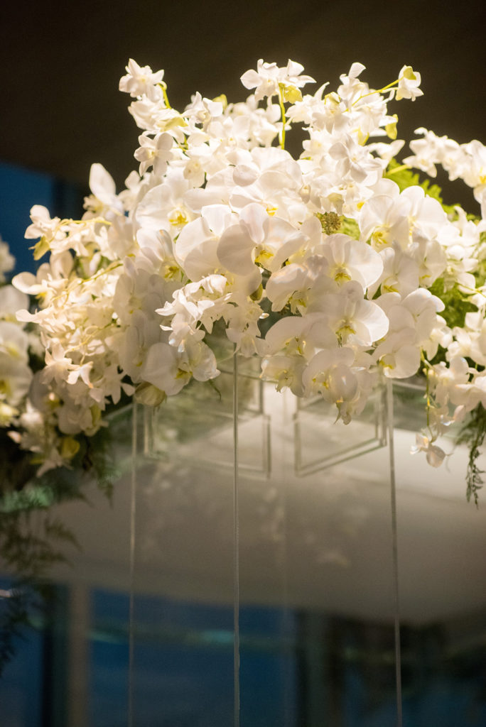 Mikkel Paige Photography wedding photos at The Glasshouses NYC. Unique clear plastic chuppah decorated with white orchids in a modern setting.
