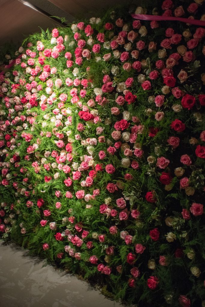 Mikkel Paige Photography wedding photos at The Glasshouses NYC. A flower wall escort card presentation with pink ribbon and calligraphy.