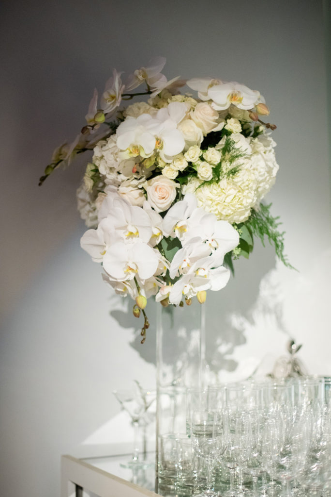 Mikkel Paige Photography wedding photos at The Glasshouses NYC. Luxury reception with white orchid floral arrangements for the bar.