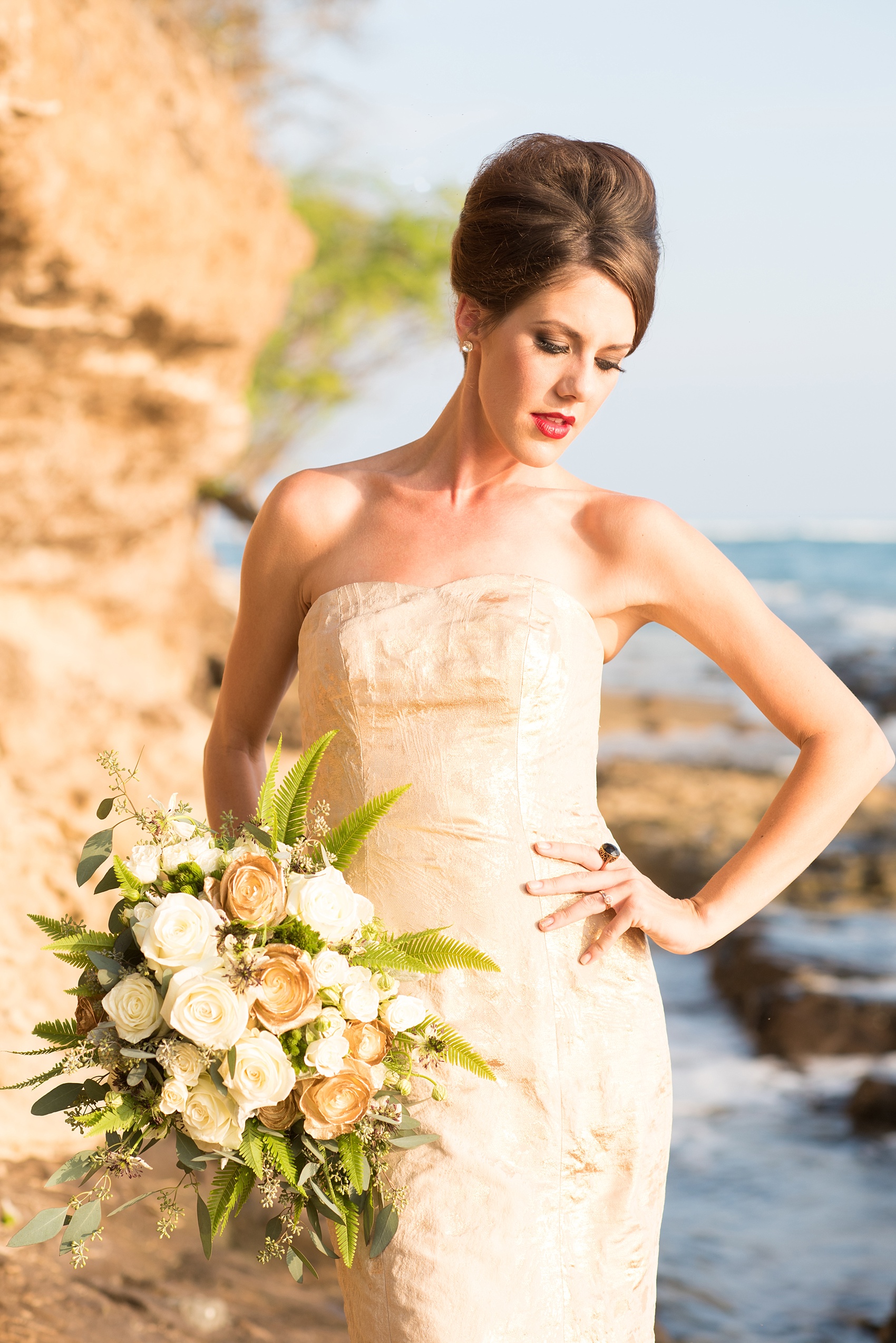 Mikkel Paige Photography photos of a bridal session on beach in Oahu. Golden hour bride with beehive up do, white and gold bouquet and with metallic gown. 