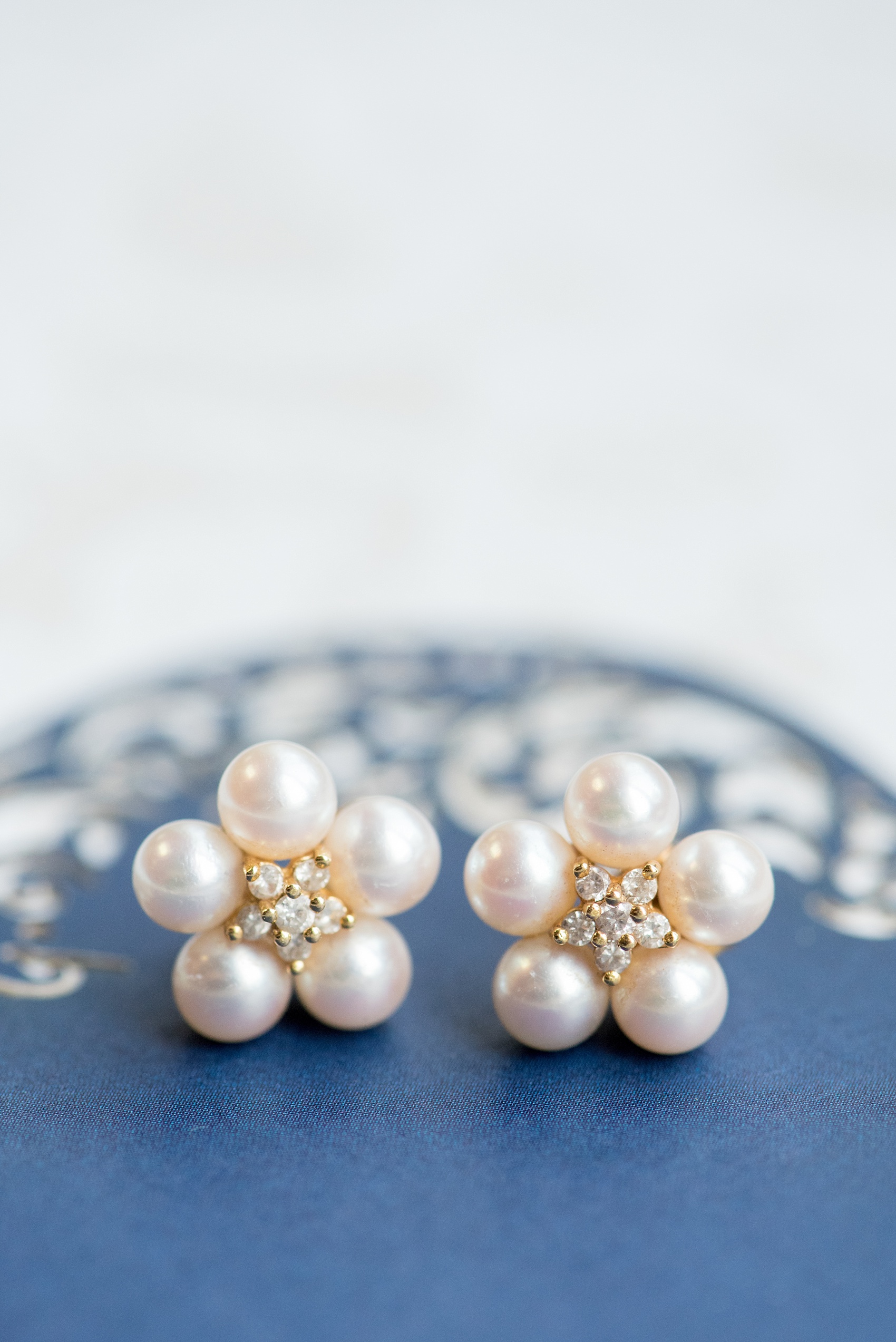 Mikkel Paige Photography photo of a wedding at the Madison Hotel in NJ. Image of the bride's pearl and diamond flower shaped earrings.