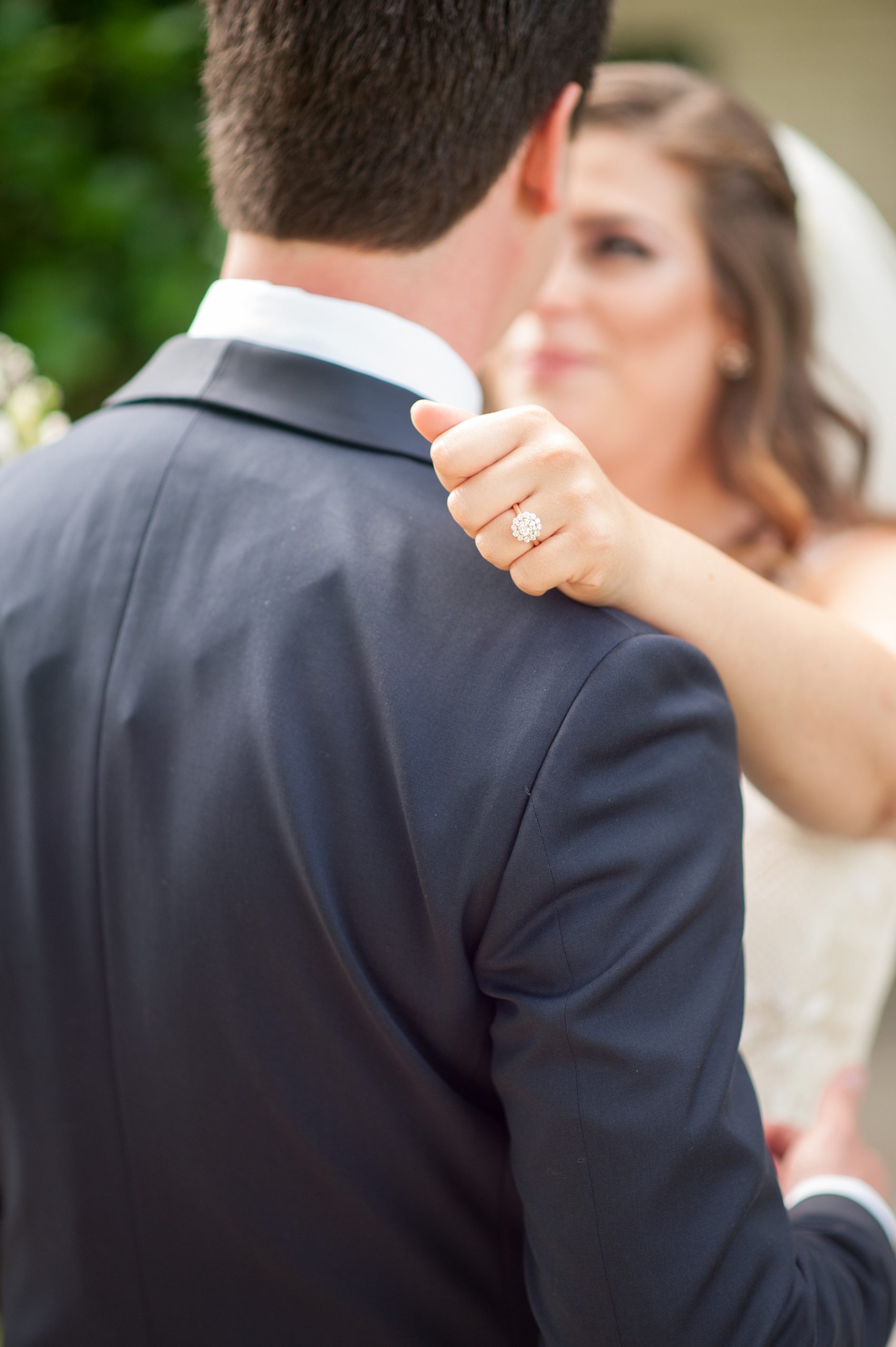 Mikkel Paige Photography photo of a wedding at the Madison Hotel in NJ. Image of the bride and groom with the bride's flower shape engagement ring.