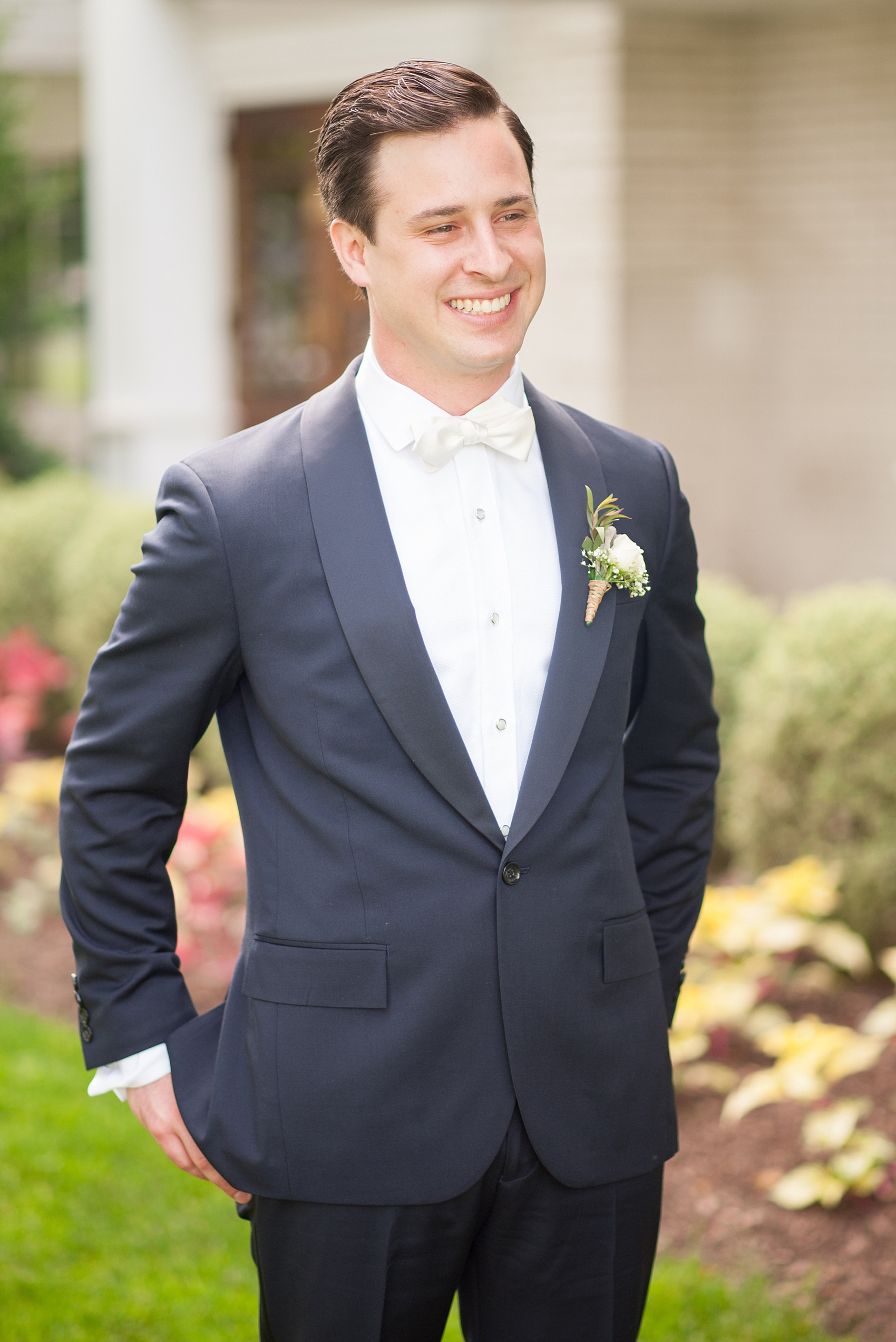Mikkel Paige Photography photo of a wedding at the Madison Hotel in NJ. Image of the groom in his navy blue JCrew tuxedo and white bow tie.