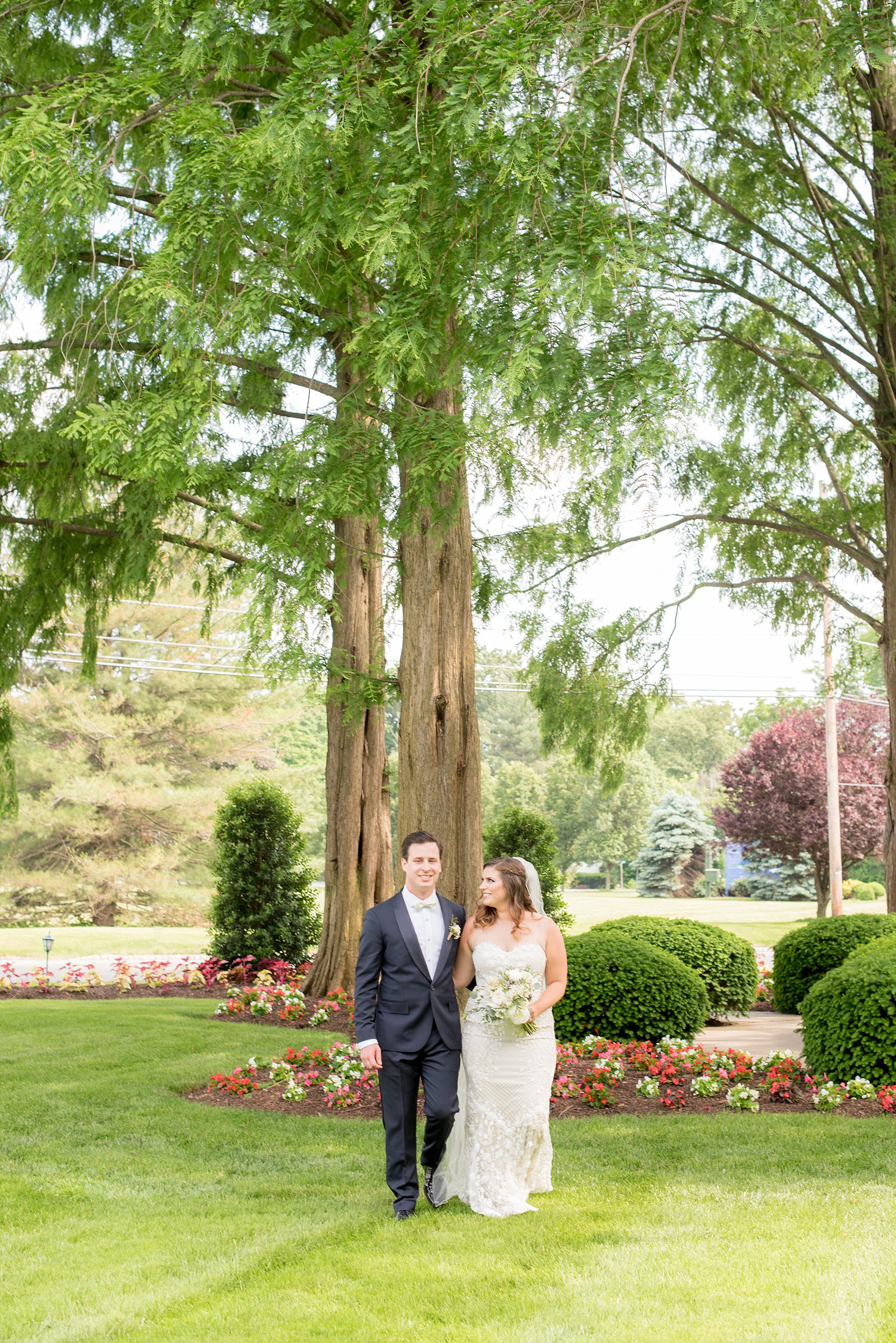 Mikkel Paige Photography photo of a wedding at the Madison Hotel in NJ. Image of the bride in and groom in front of the white building. 