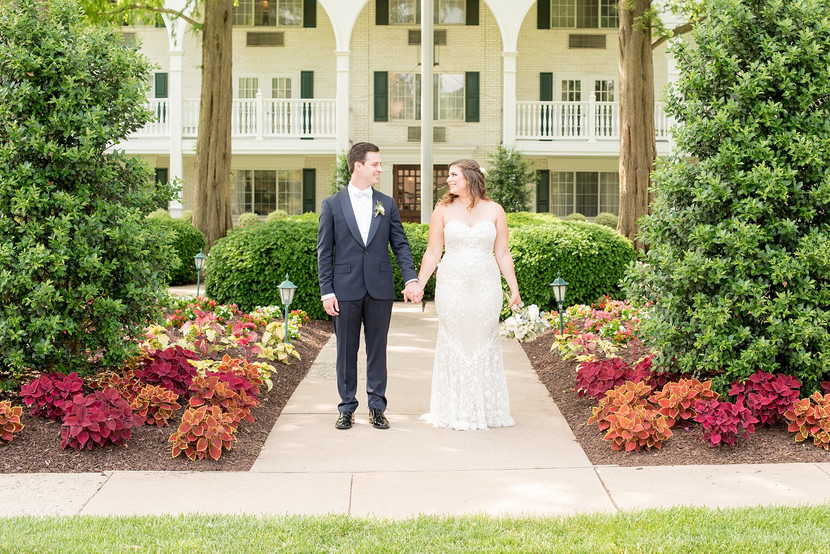 Mikkel Paige Photography photo of a wedding at the Madison Hotel in NJ. Image of the bride in and groom in front of the white building.