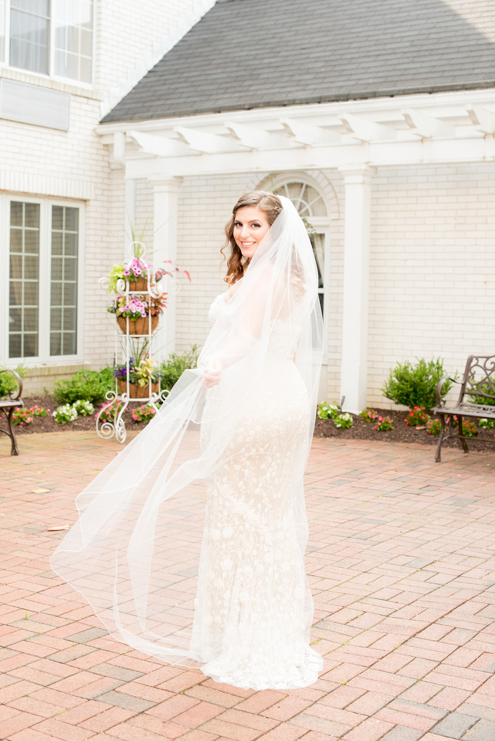 Mikkel Paige Photography photo of a wedding at the Madison Hotel in NJ. Image of the bride in her veil and fitted, beaded BHLDN gown.