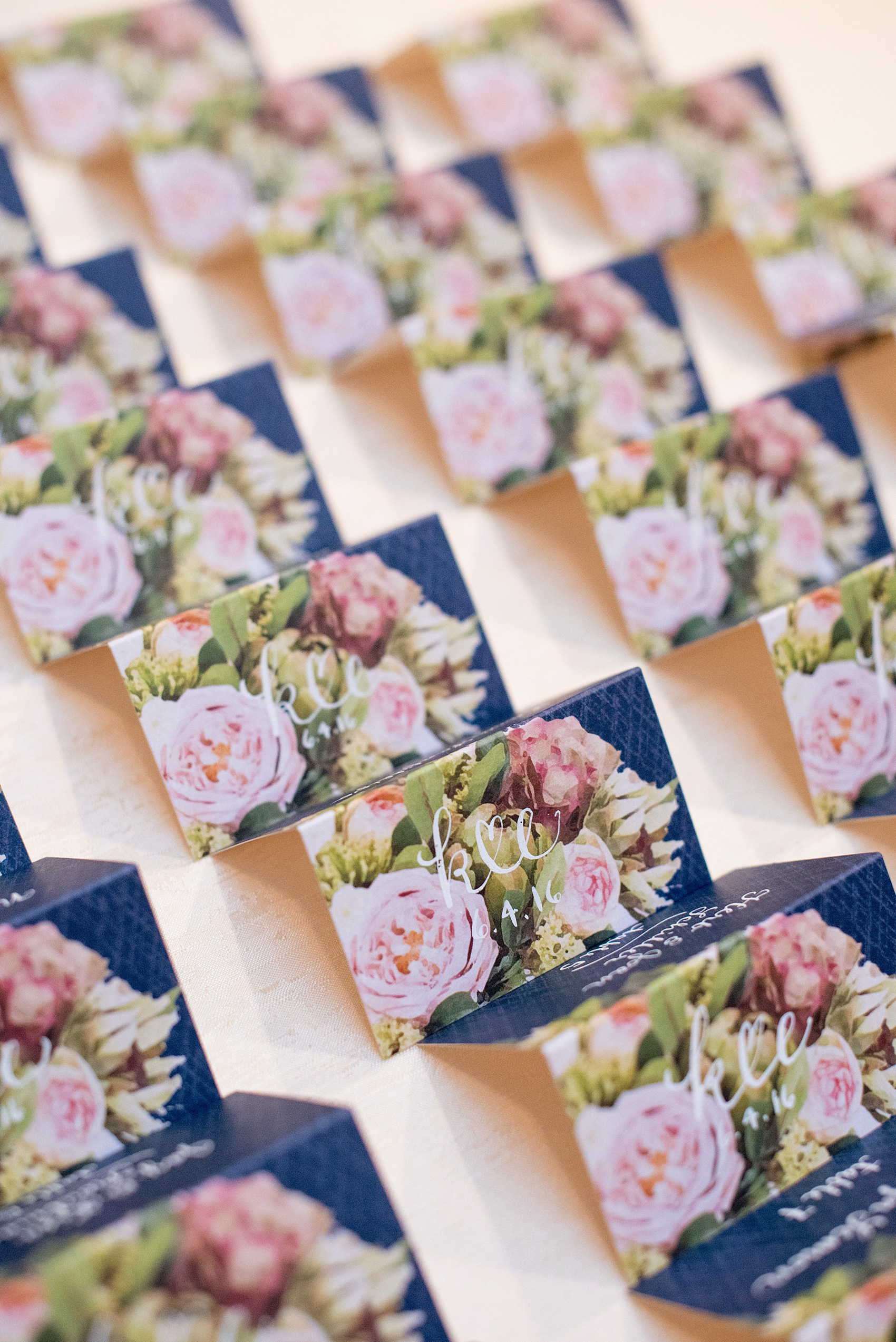Mikkel Paige Photography photo of a wedding at the Madison Hotel in NJ. Image of the double-sided navy floral escort cards.