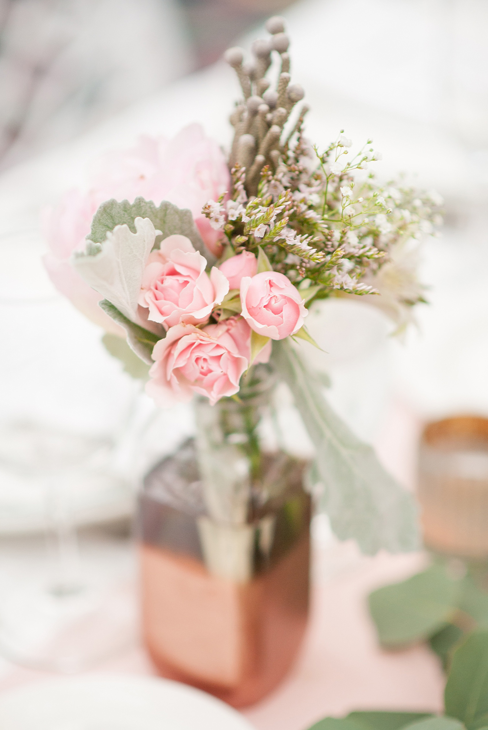 Mikkel Paige Photography photo of a wedding at the Madison Hotel in NJ. Photo of the white table at the reception in The Conservatory with pink roses in bud vases.