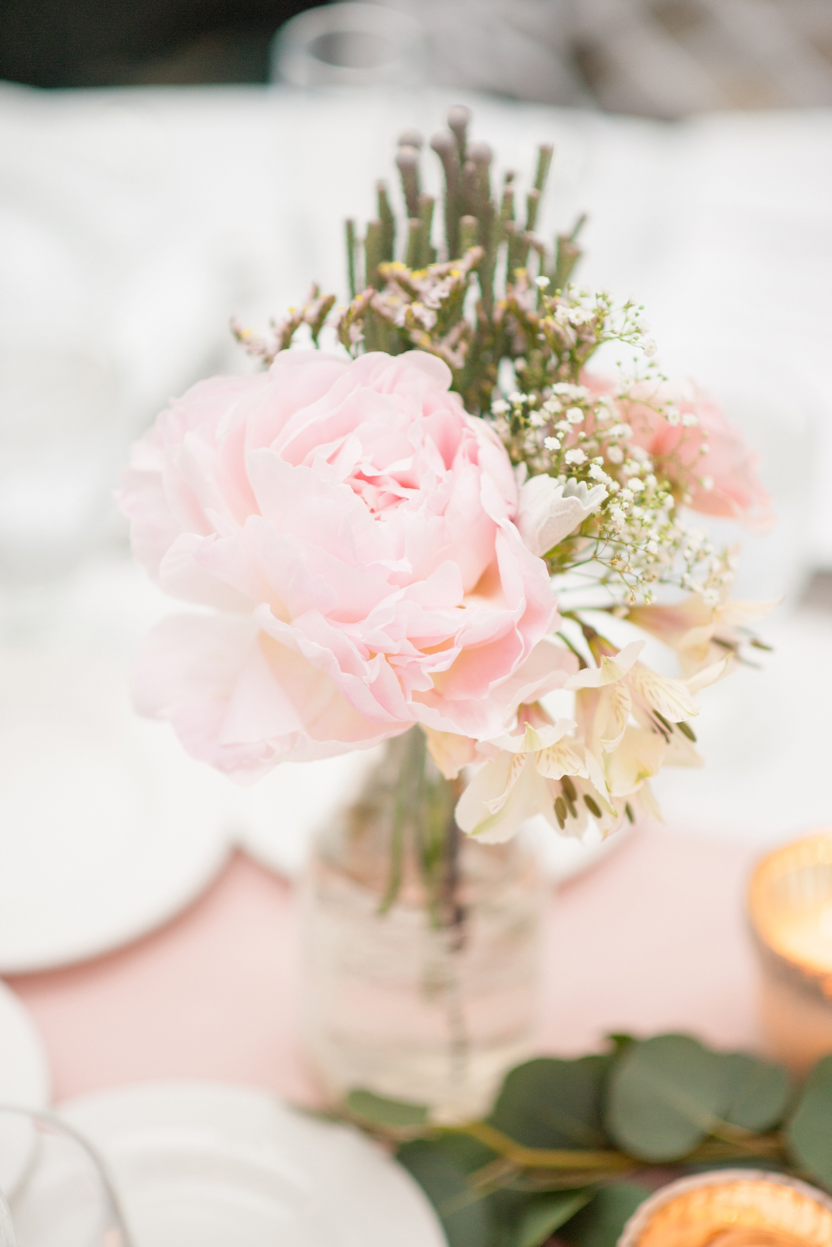 Mikkel Paige Photography photo of a wedding at the Madison Hotel in NJ. Photo of the white table at the reception in The Conservatory with pink peonies in bud vases.