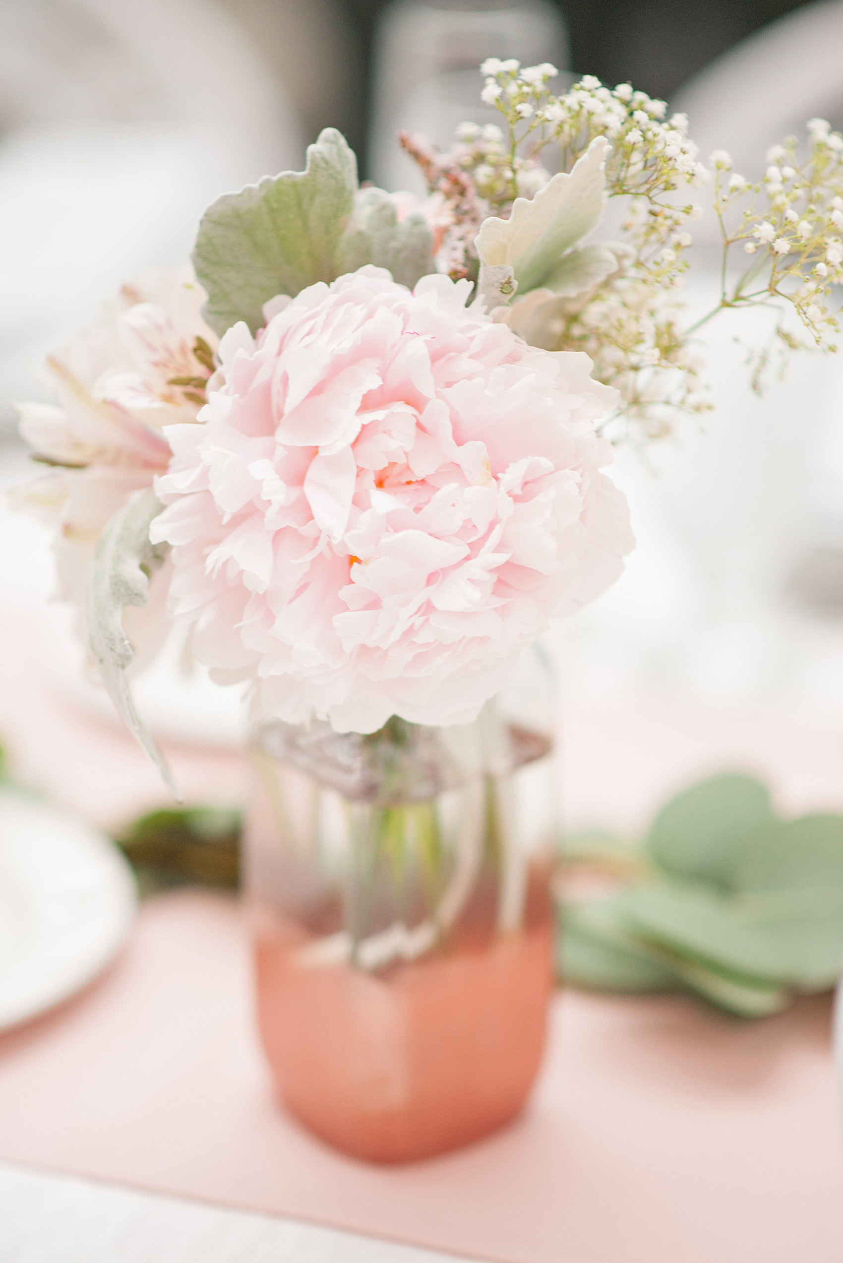 Mikkel Paige Photography photo of a wedding at the Madison Hotel in NJ. Photo of the white table at the reception in The Conservatory with pink peonies in bud vases.