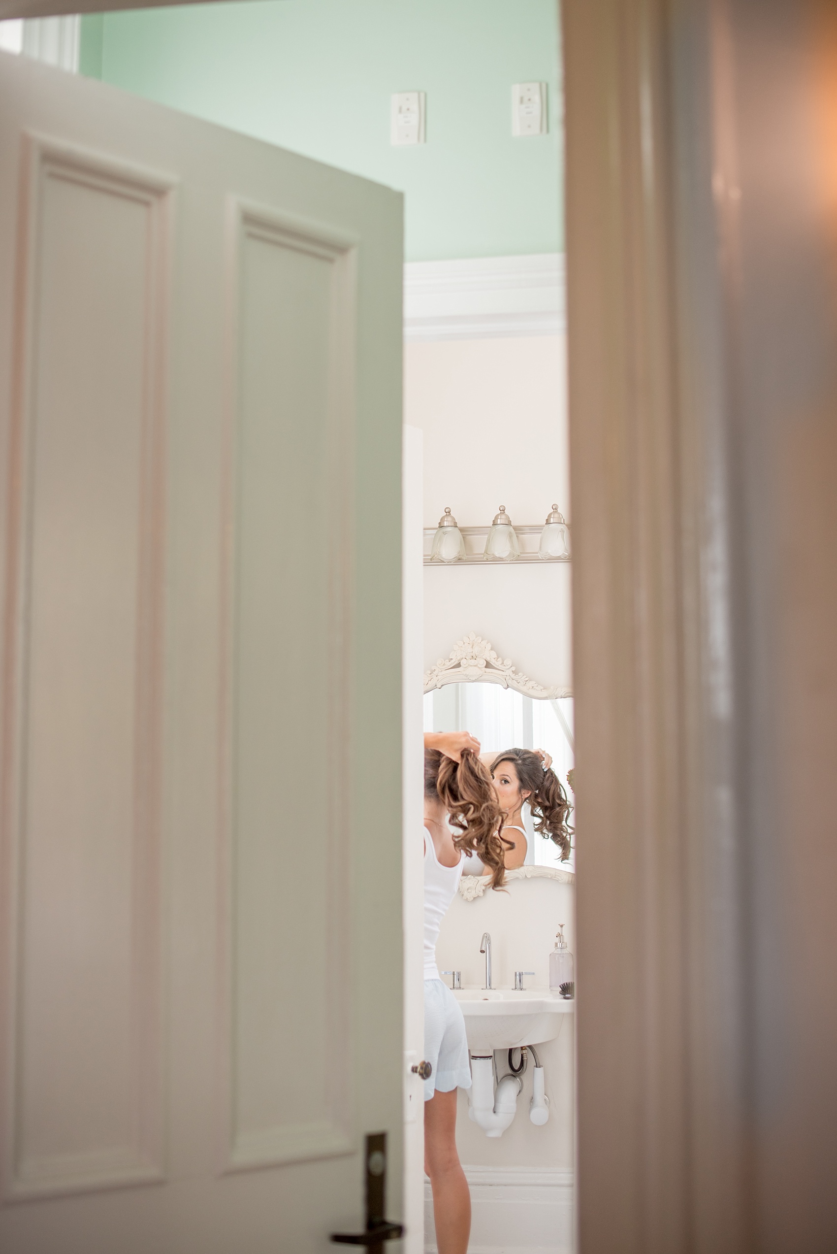 Mikkel Paige Photography wedding photos at The Merrimon-Wynne House in downtown Raleigh. The bridal party gets ready in matching outfits with monogrammed seersucker shorts from the bride.