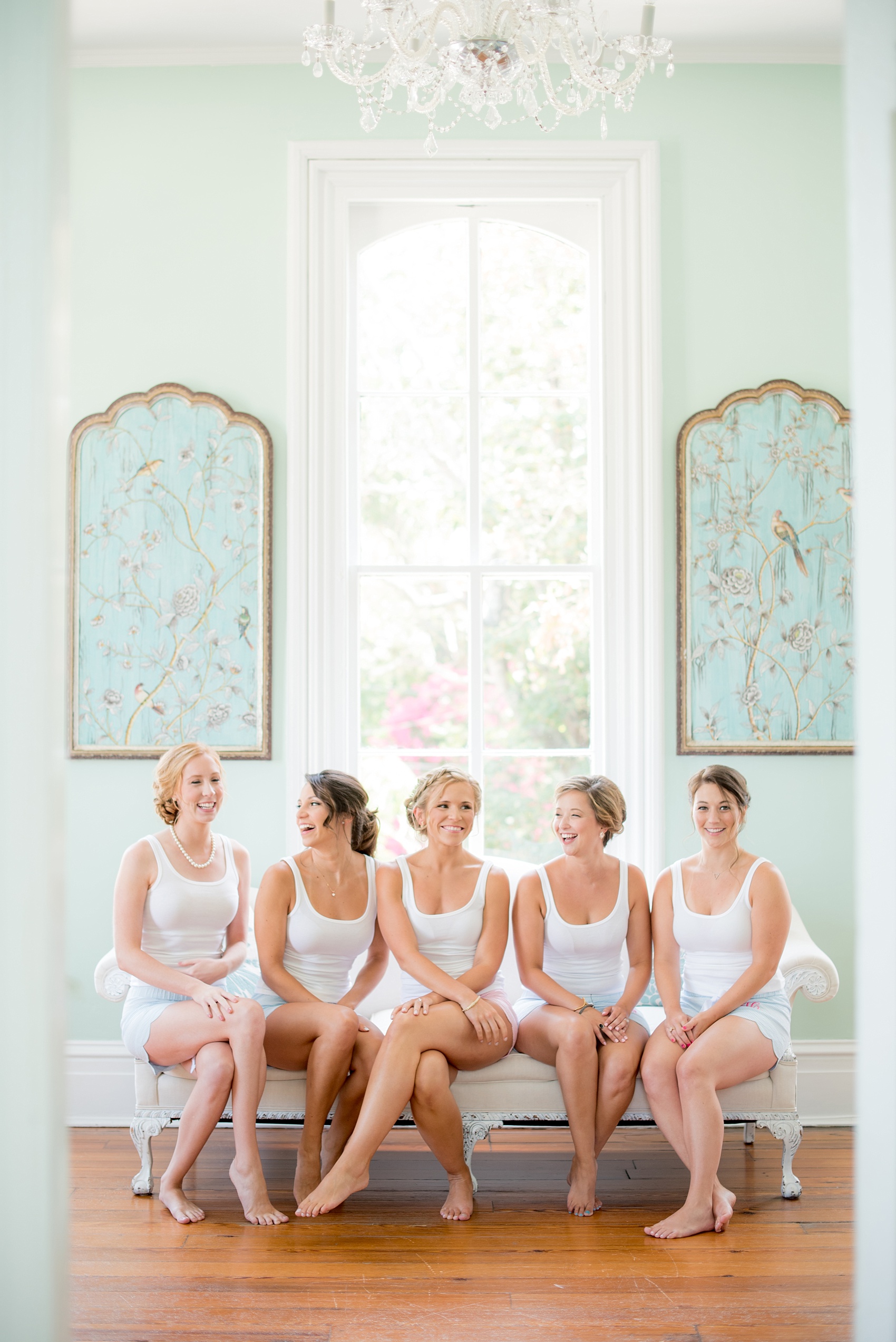 Mikkel Paige Photography wedding photos at The Merrimon-Wynne House in downtown Raleigh. The bridal party gets ready in matching outfits with monogrammed seersucker shorts from the bride.