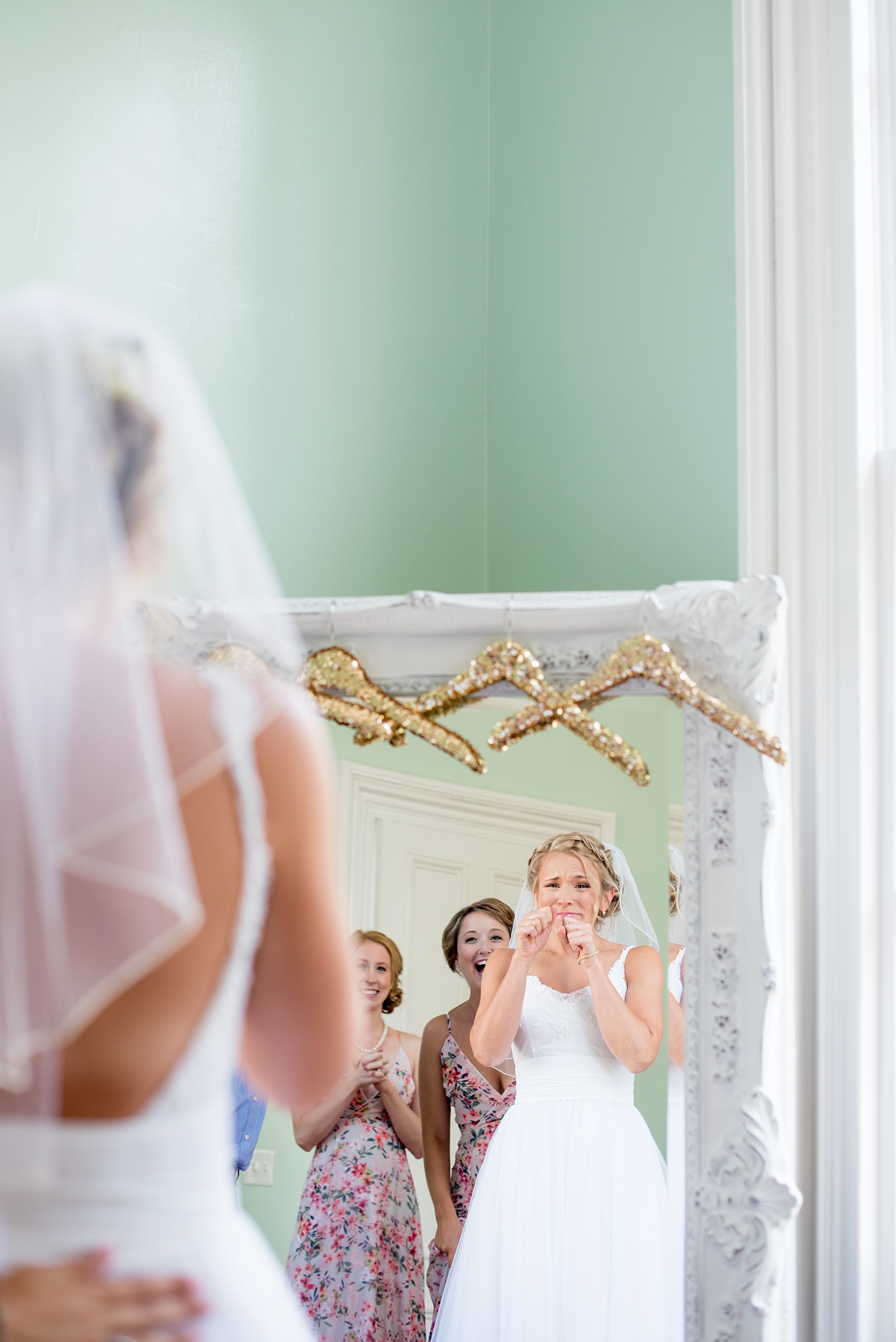 Mikkel Paige Photography wedding photos at The Merrimon-Wynne House in downtown Raleigh. The bride gets ready with her bridal party and sees herself in the mirror for the first time.