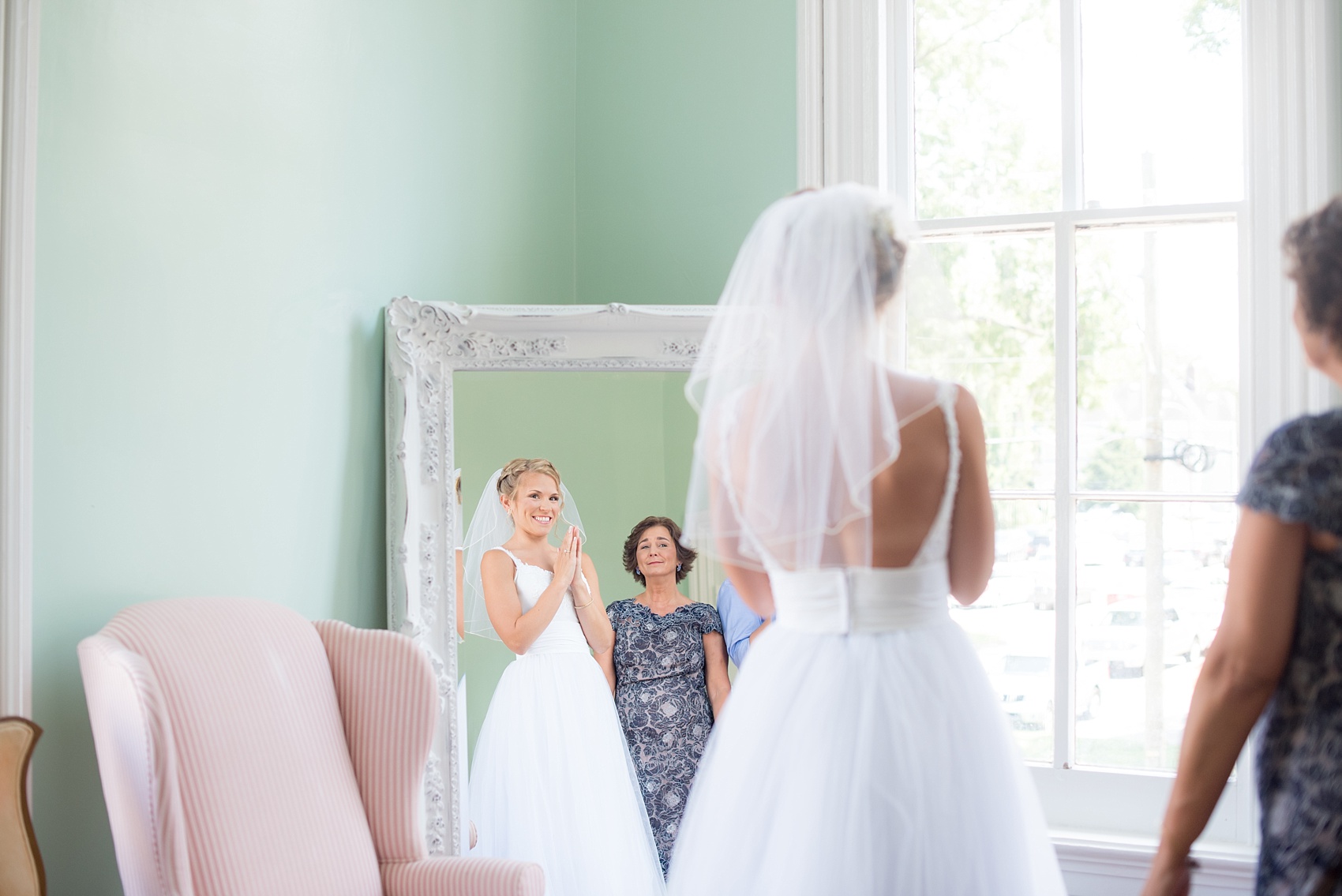 Mikkel Paige Photography wedding photos at The Merrimon-Wynne House in downtown Raleigh. The bride gets ready with her bridal party and sees herself in the mirror for the first time.