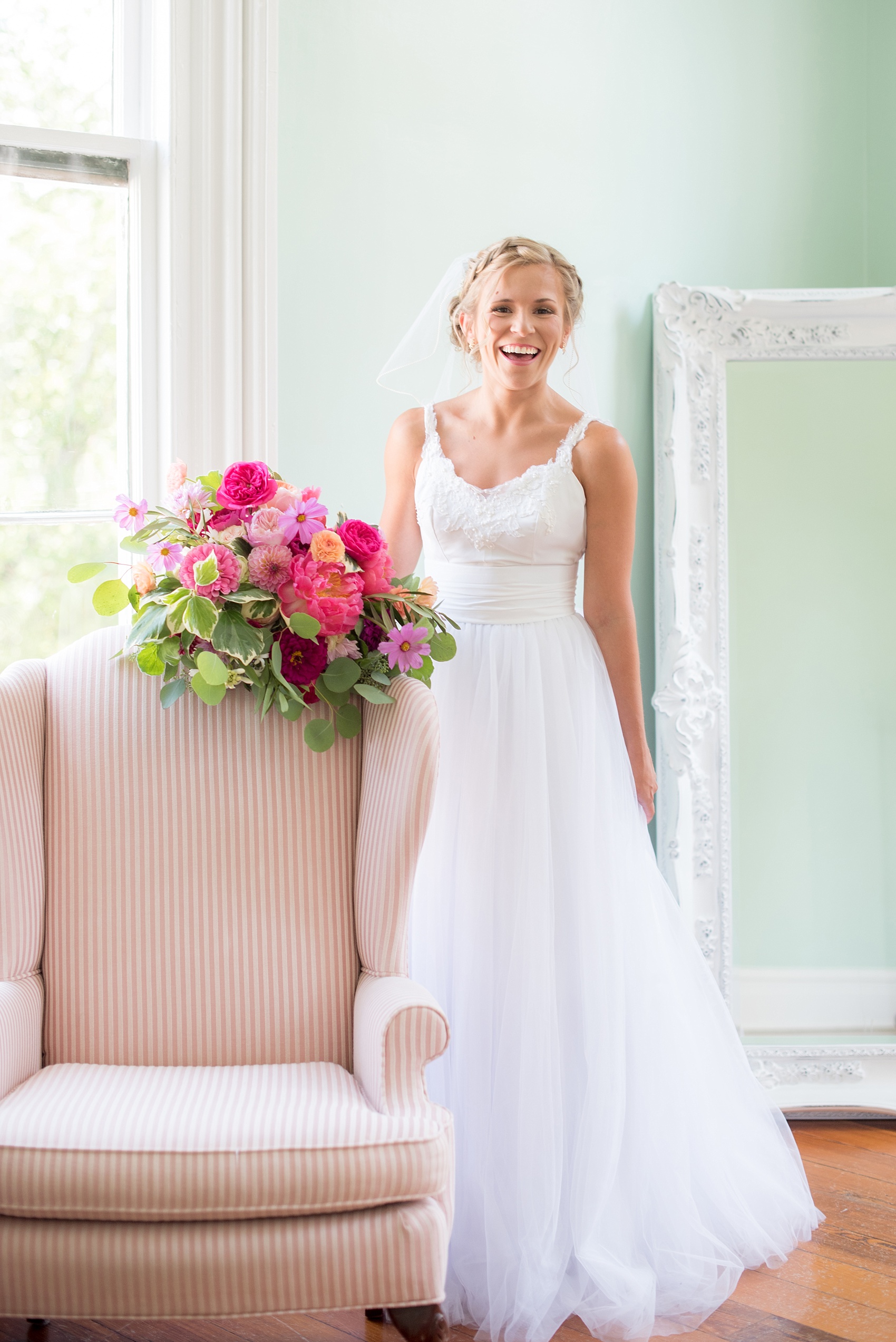 Mikkel Paige Photography wedding photos at The Merrimon-Wynne House in downtown Raleigh. A bridal portrait with the bride's tulle skirt and colorful bouquet by Meristem Floral.