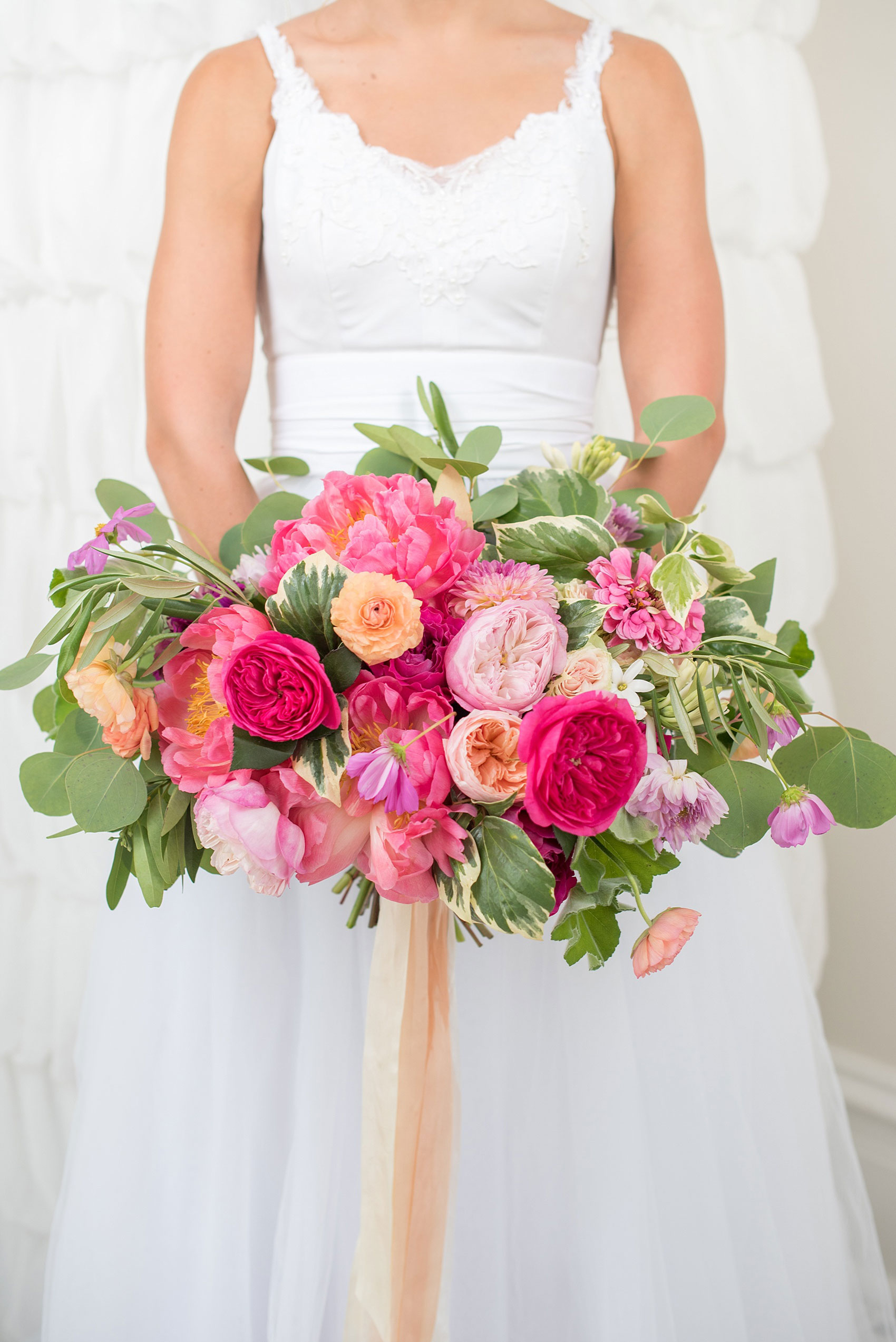 Mikkel Paige Photography wedding photos at The Merrimon-Wynne House in downtown Raleigh. A bridal portrait with the bride's tulle skirt and colorful bouquet by Meristem Floral.