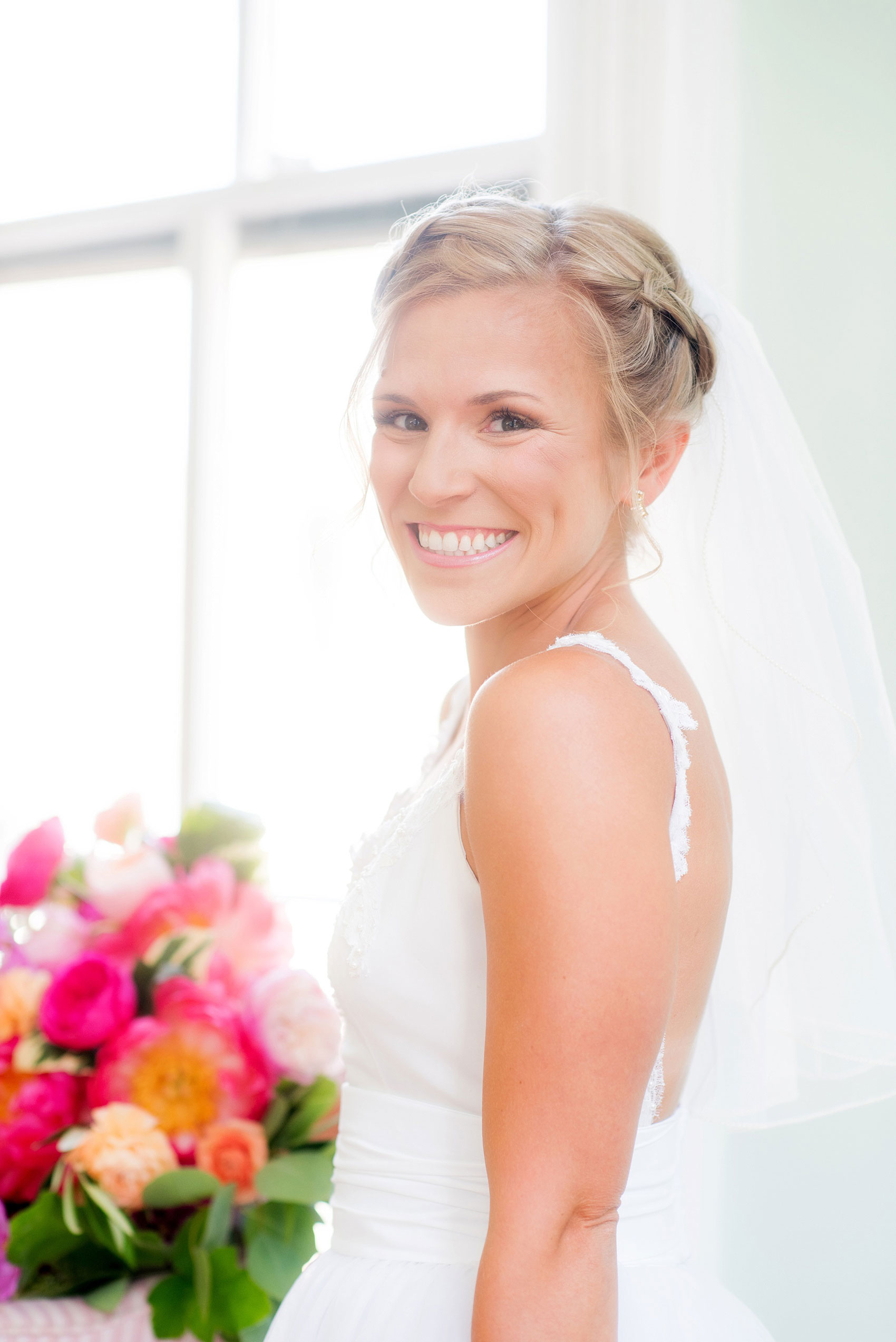 Mikkel Paige Photography wedding photos at The Merrimon-Wynne House in downtown Raleigh. The bride had a reverse braid crown hair up-do, low back gown and colorful bouquet by Meristem Floral. 