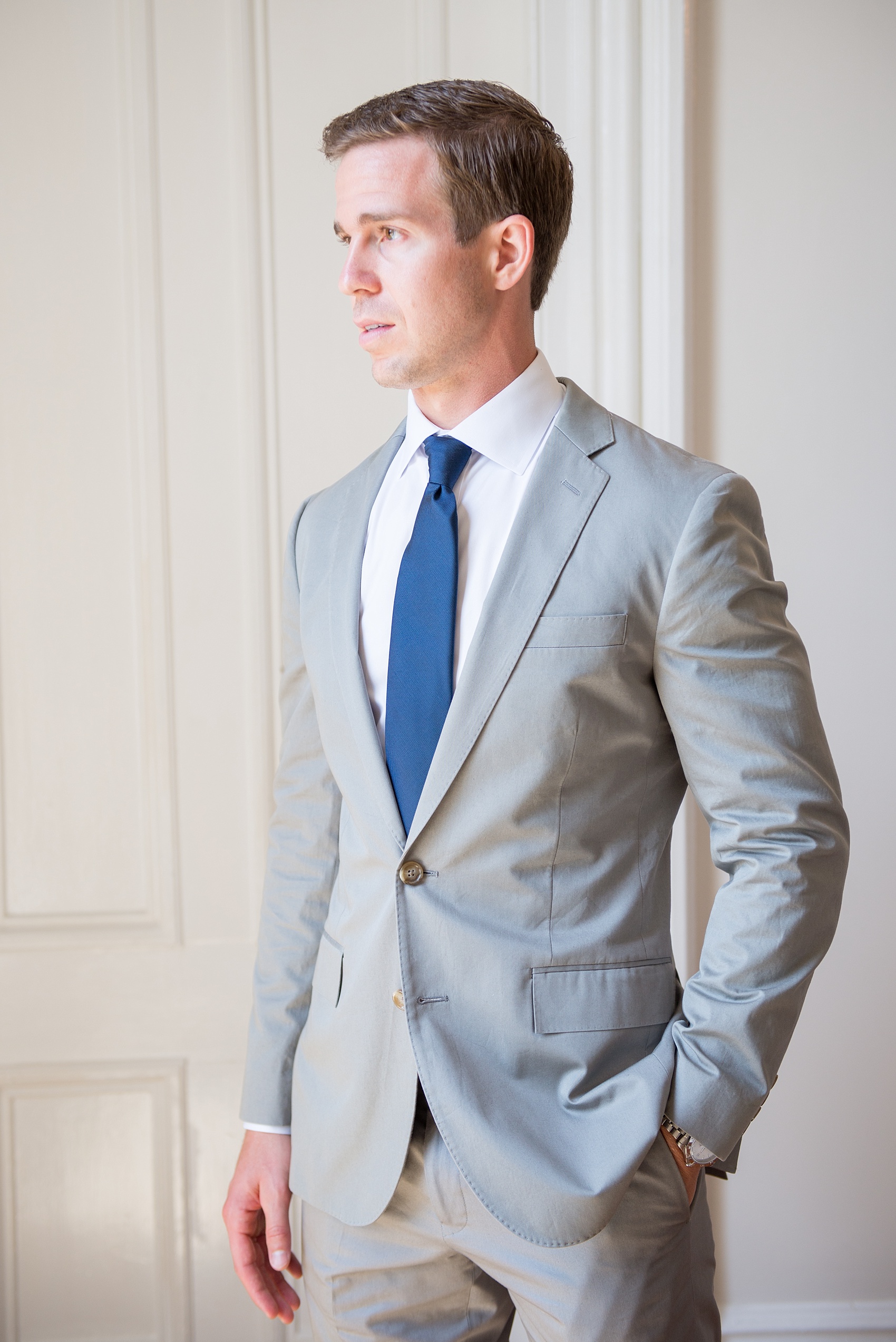 Mikkel Paige Photography wedding photos at The Merrimon-Wynne House in downtown Raleigh. The groom prepares for his day with a blue tie and grey suit.