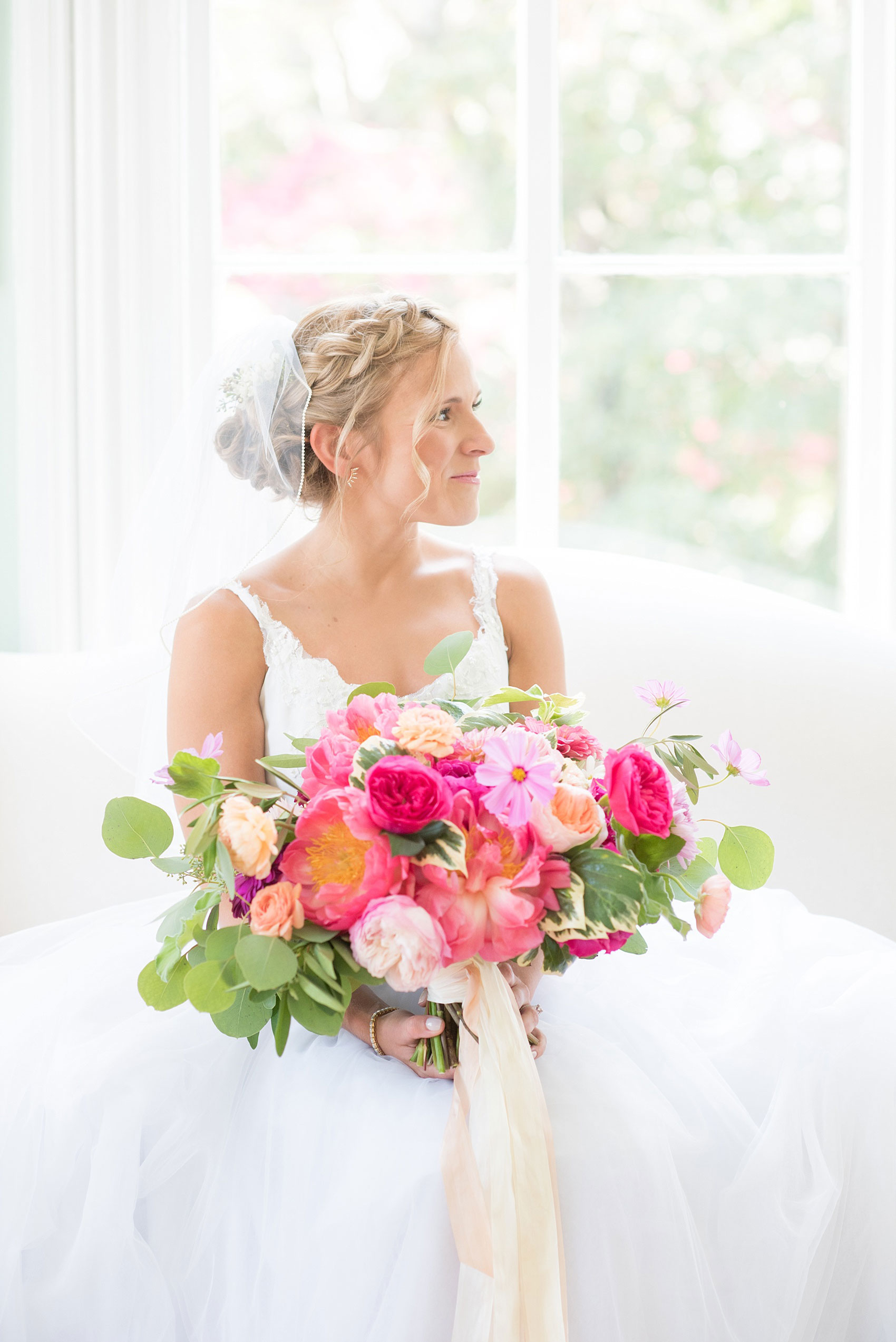 Mikkel Paige Photography wedding photos at The Merrimon-Wynne House in downtown Raleigh. A bridal portrait with the bride's tulle skirt and colorful bouquet by Meristem Floral.