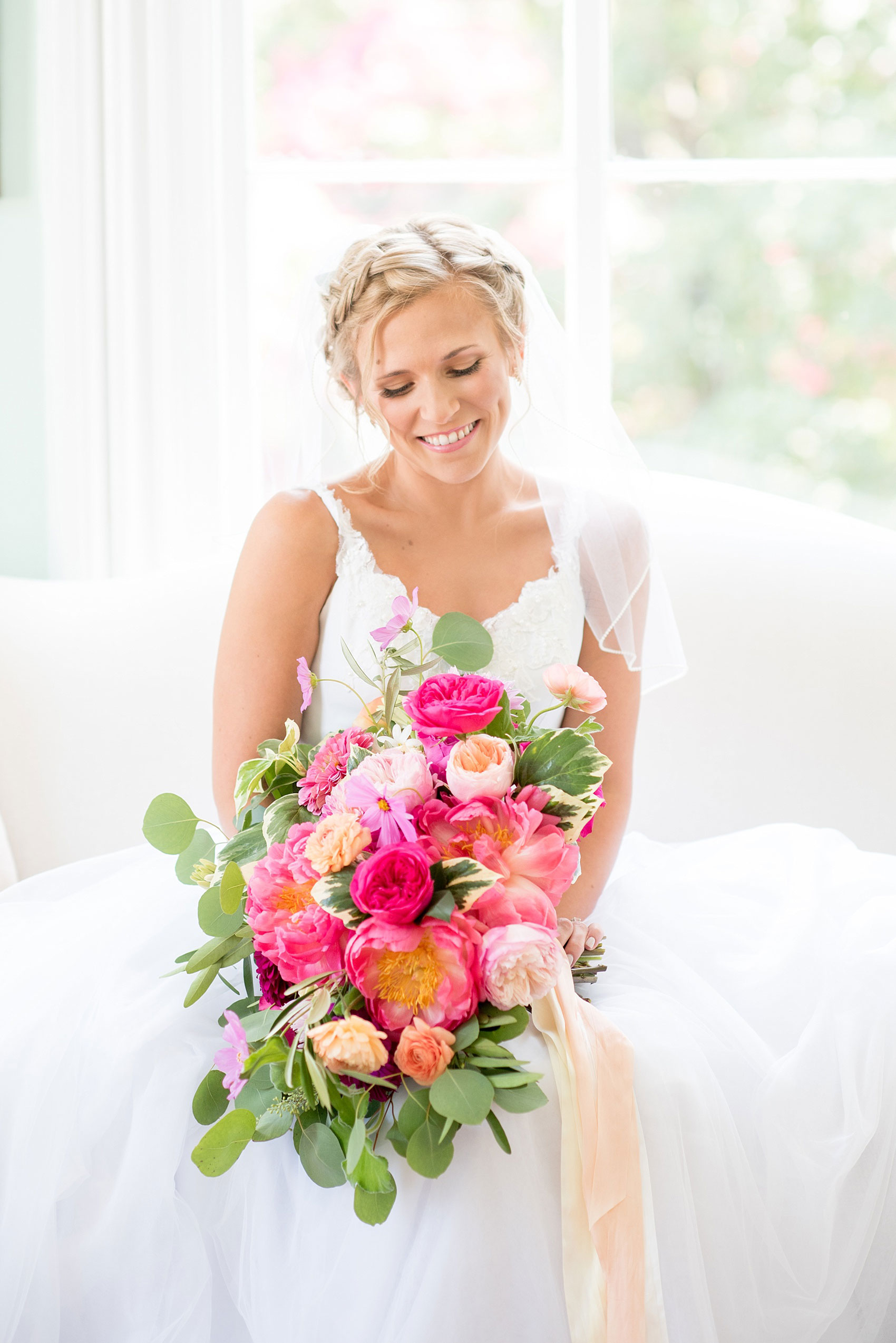 Mikkel Paige Photography wedding photos at The Merrimon-Wynne House in downtown Raleigh. A bridal portrait with the bride's tulle skirt and colorful bouquet by Meristem Floral.