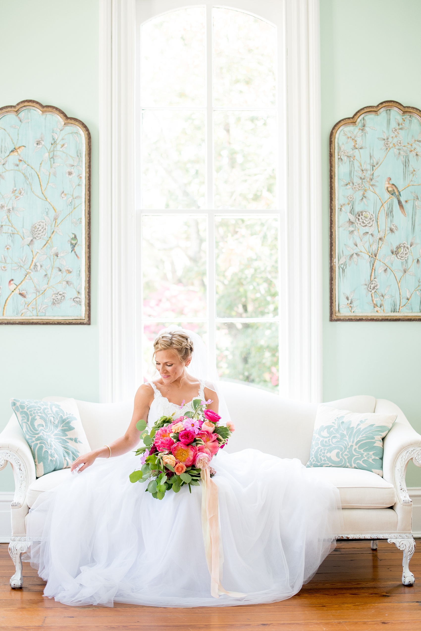 Mikkel Paige Photography wedding photos at The Merrimon-Wynne House in downtown Raleigh. A bridal portrait with the bride's tulle skirt and colorful bouquet by Meristem Floral.