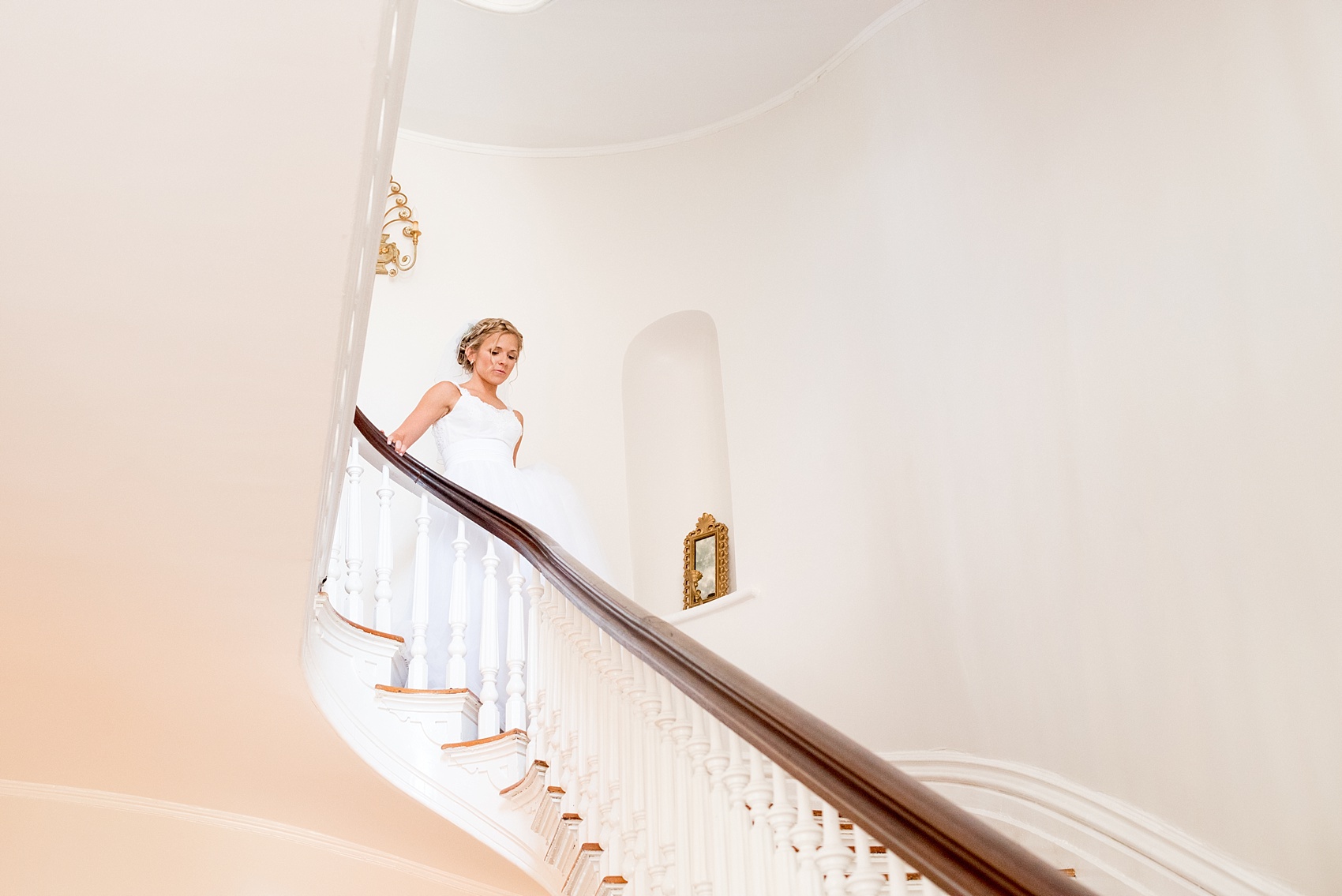 Mikkel Paige Photography wedding photos at The Merrimon-Wynne House in downtown Raleigh. The bride walks down a beautiful staircase in this picture for her first look.