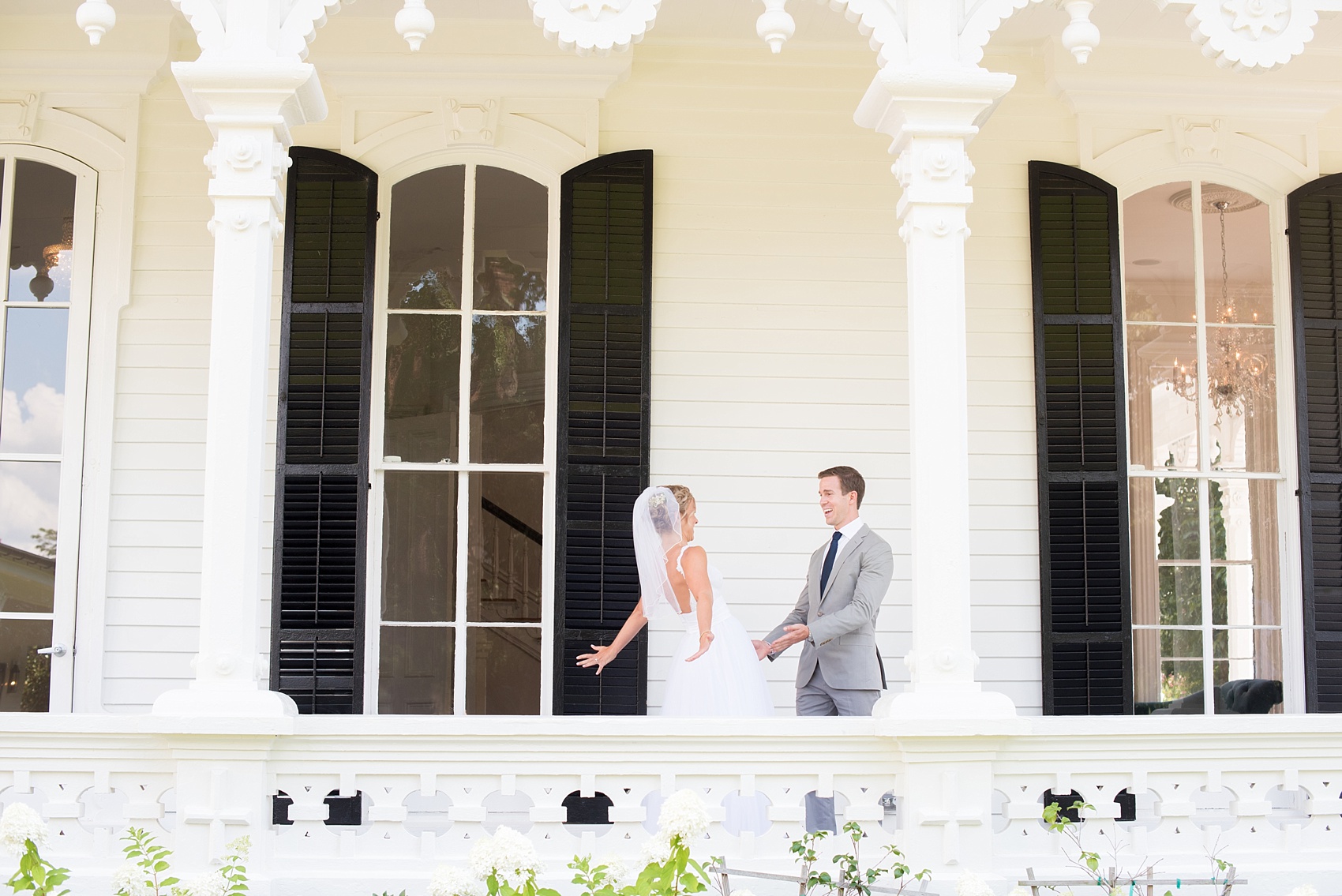 Mikkel Paige Photography wedding photos at The Merrimon-Wynne House in downtown Raleigh. A picture of the bride and groom's first look on the southern porch.