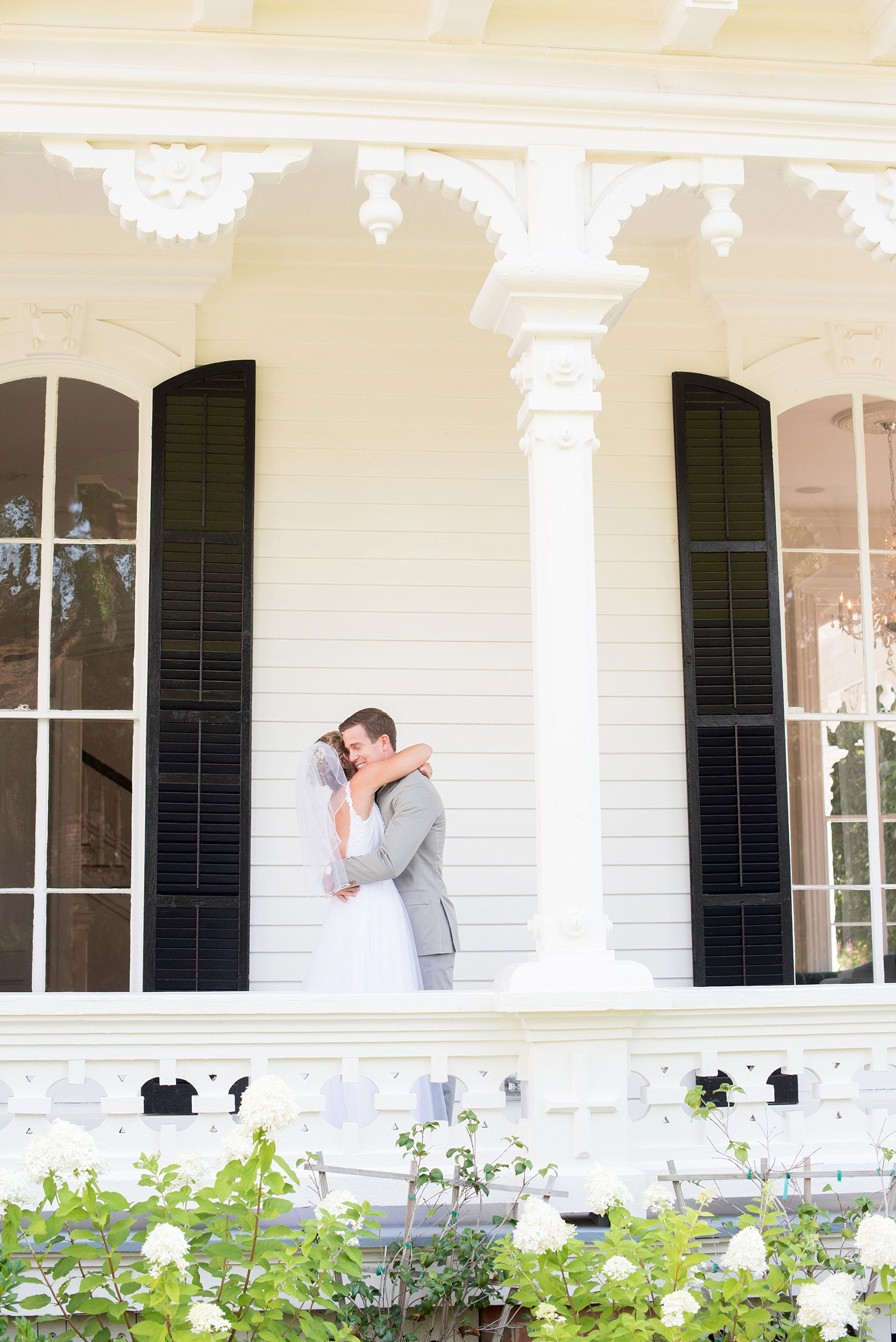 Mikkel Paige Photography wedding photos at The Merrimon-Wynne House in downtown Raleigh. A picture of the bride and groom's first look on the southern porch.