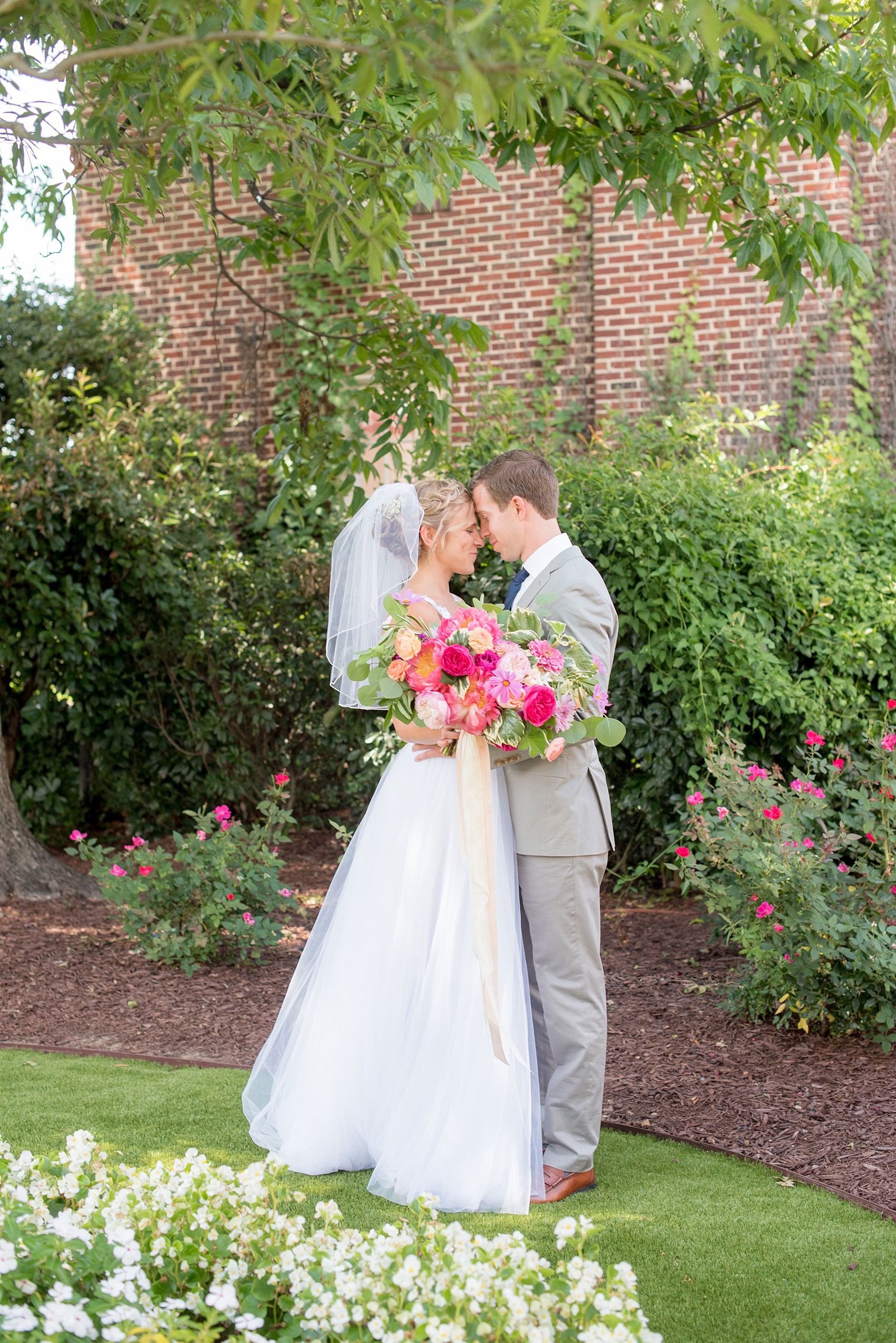 Mikkel Paige Photography wedding photos at The Merrimon-Wynne House in downtown Raleigh. The bride and groom with colorful bouquet and tulle skirt wedding dress.
