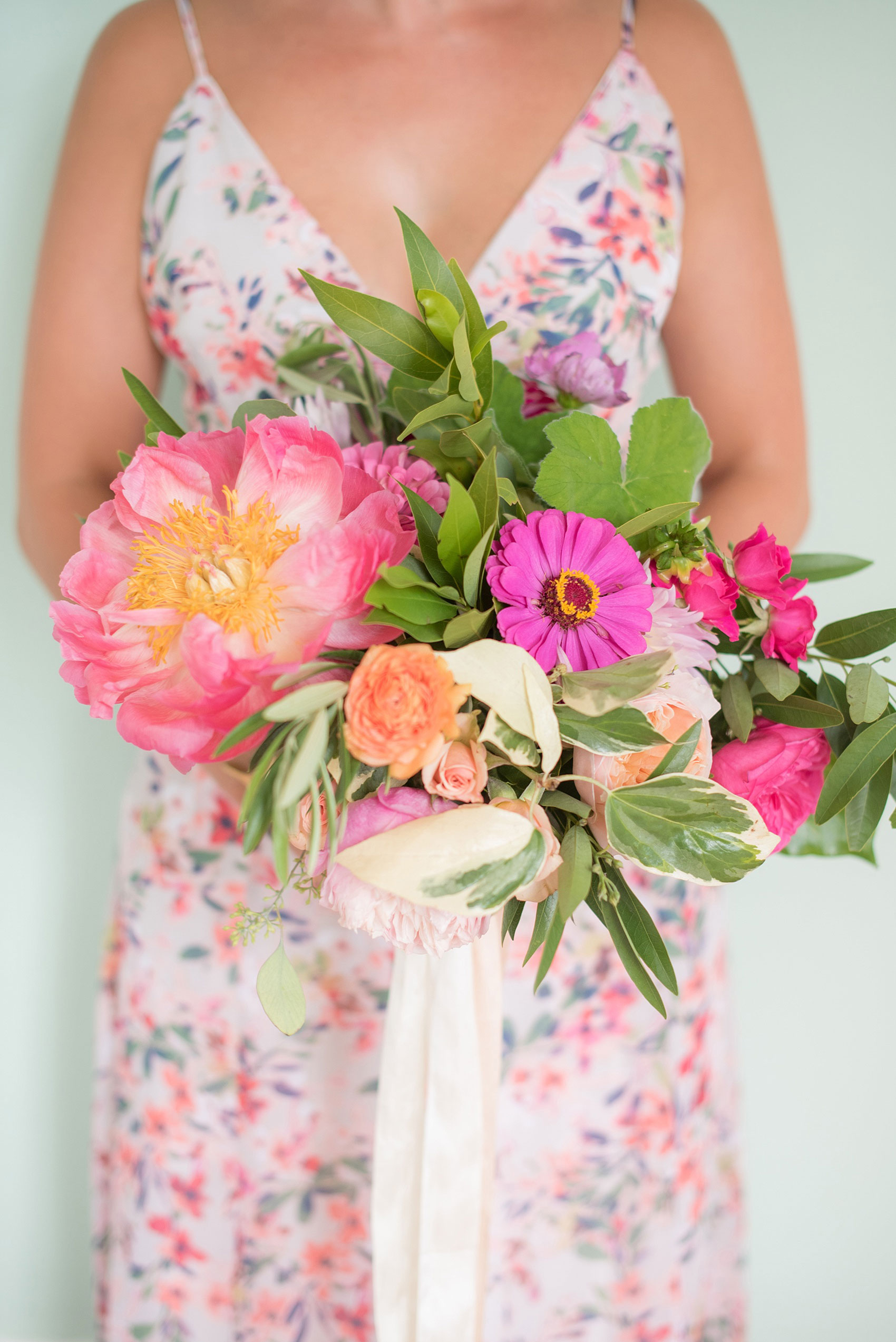 Mikkel Paige Photography wedding photos at The Merrimon-Wynne House in downtown Raleigh. Bridesmaids in floral maxi gowns with colorful pink, orange and green bouquets with peonies, eucalyptus and garden roses by Meristem Floral. 