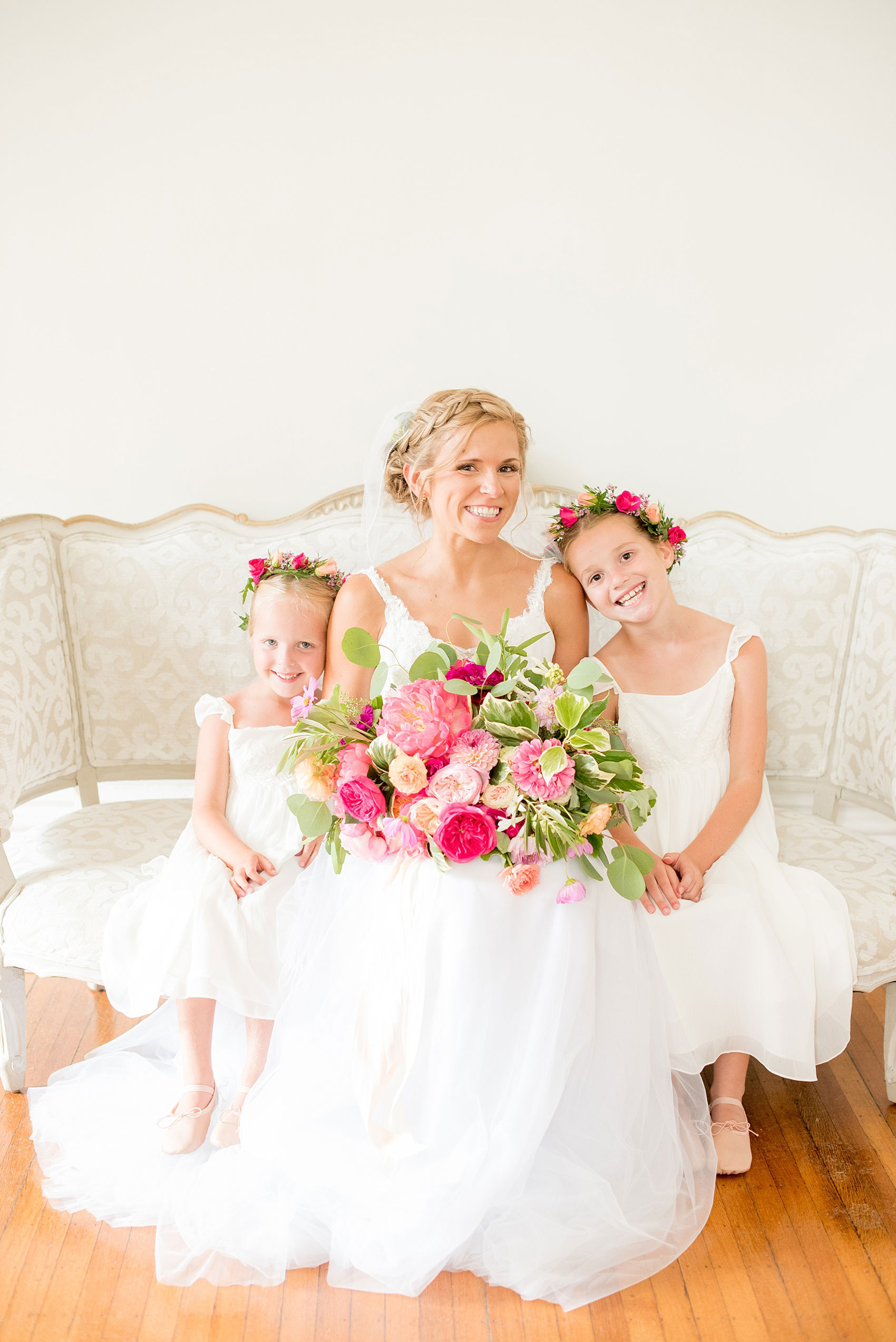 Mikkel Paige Photography wedding photos at The Merrimon-Wynne House in downtown Raleigh. The bride with her two flower girls in colorful floral crowns by Meristem Floral.