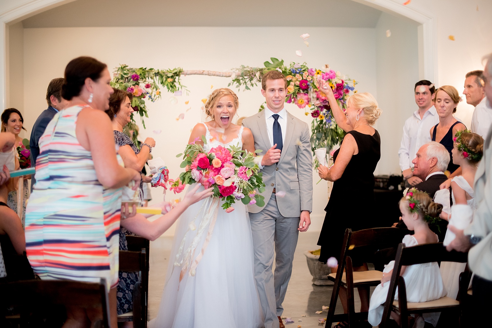 Mikkel Paige Photography wedding photos at The Merrimon-Wynne House in downtown Raleigh. The bride and groom after their ceremony, with rose petal toss!