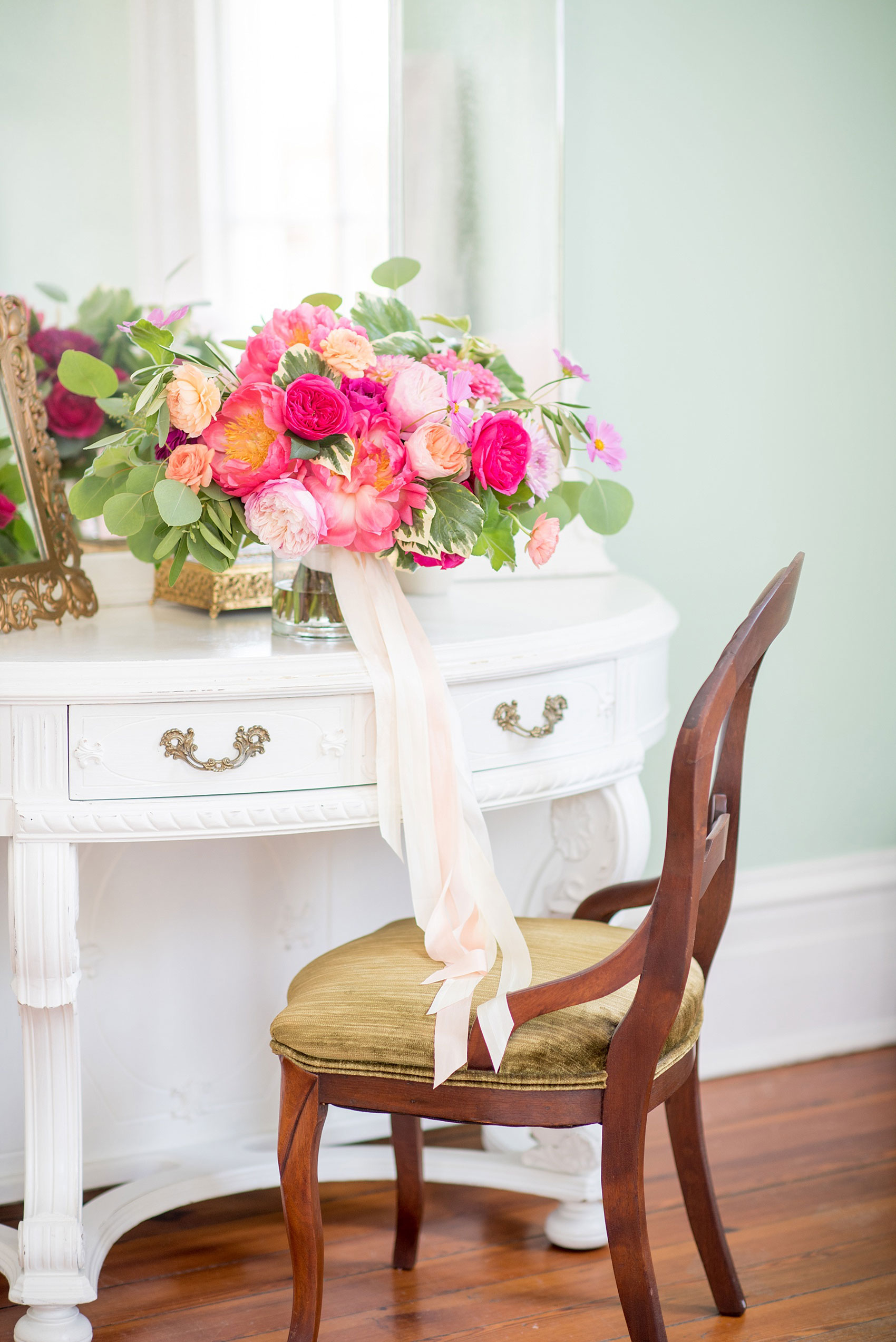 Mikkel Paige Photography wedding photos at The Merrimon-Wynne House in downtown Raleigh. The bride carried a colorful full bouquet with dahlias, garden roses, eucalyptus and peonies, complete with long silk ribbon wrap by Meristem Floral.