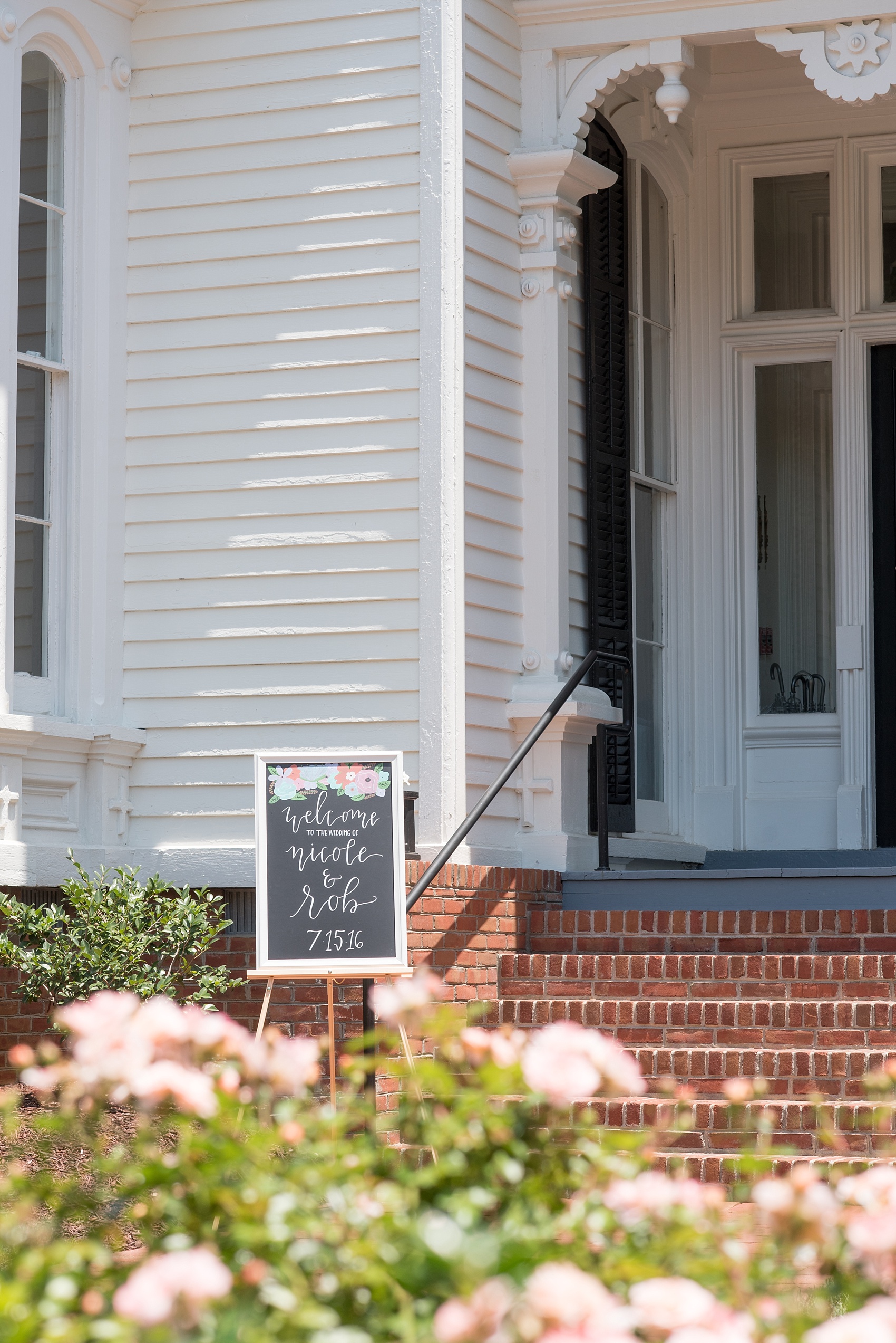 Mikkel Paige Photography wedding photos at The Merrimon-Wynne House in downtown Raleigh. A custom chalkboard sign welcomes guests to the southern venue.