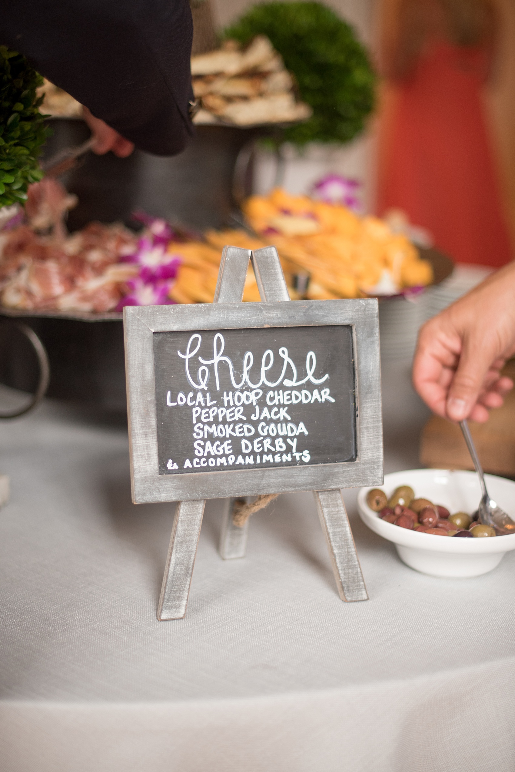 Mikkel Paige Photography wedding photos at The Merrimon-Wynne House in downtown Raleigh. A photo of the cocktail hour chalkboard sign and antipasto from Rocky Top Catering.